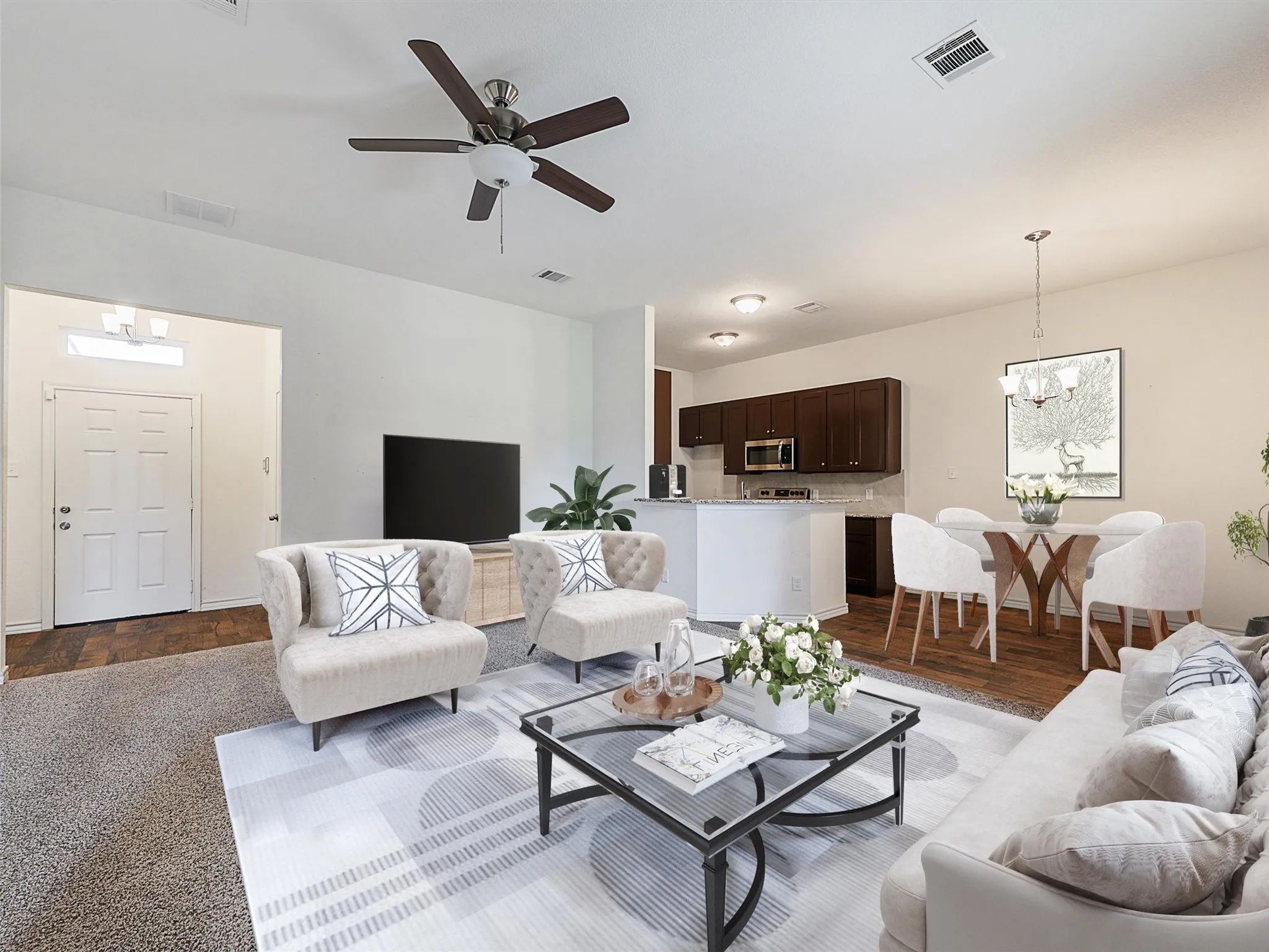 Living room featuring a ceiling fan, suspended lighting, and wood finished floors