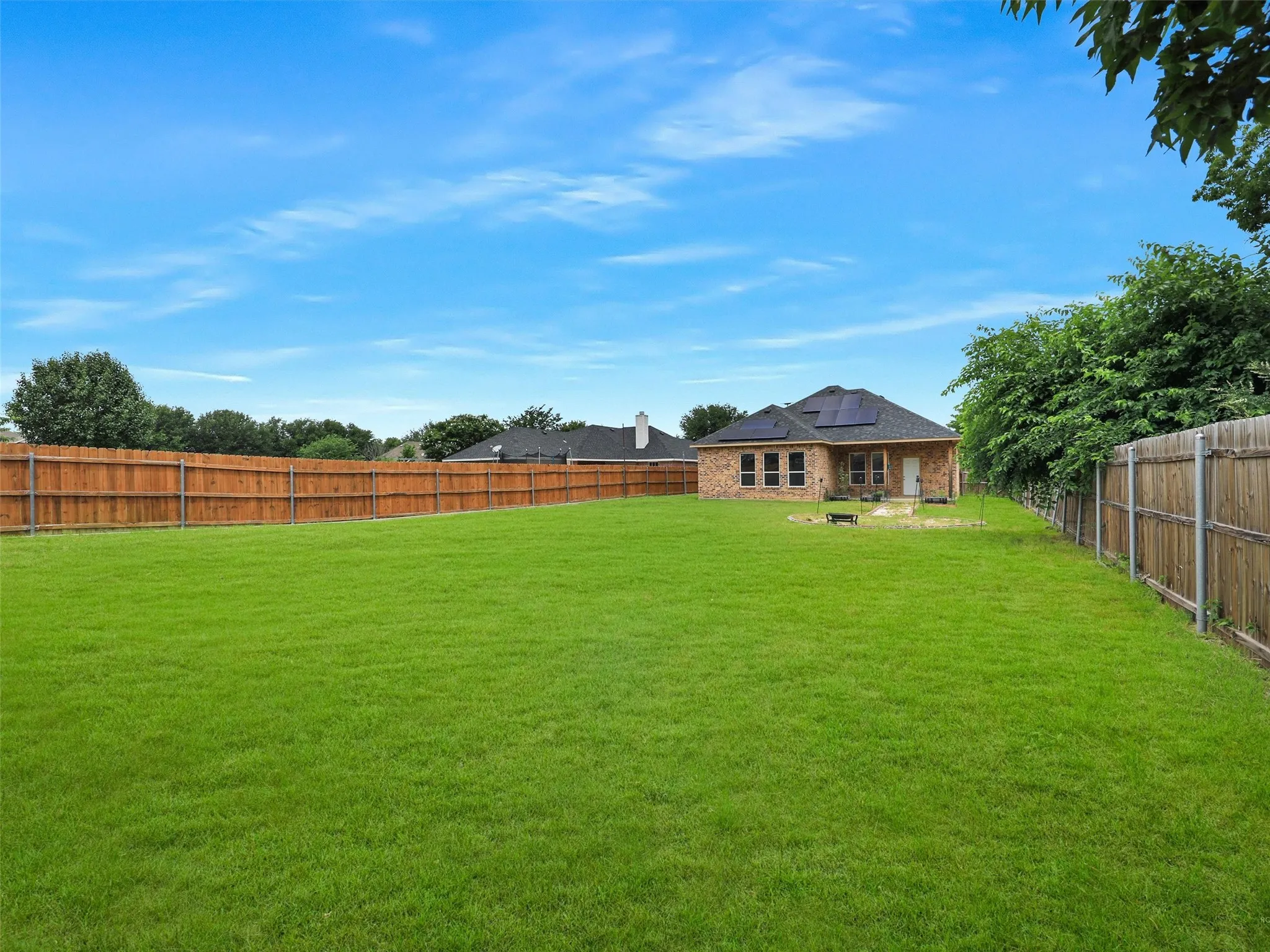 View of fenced backyard