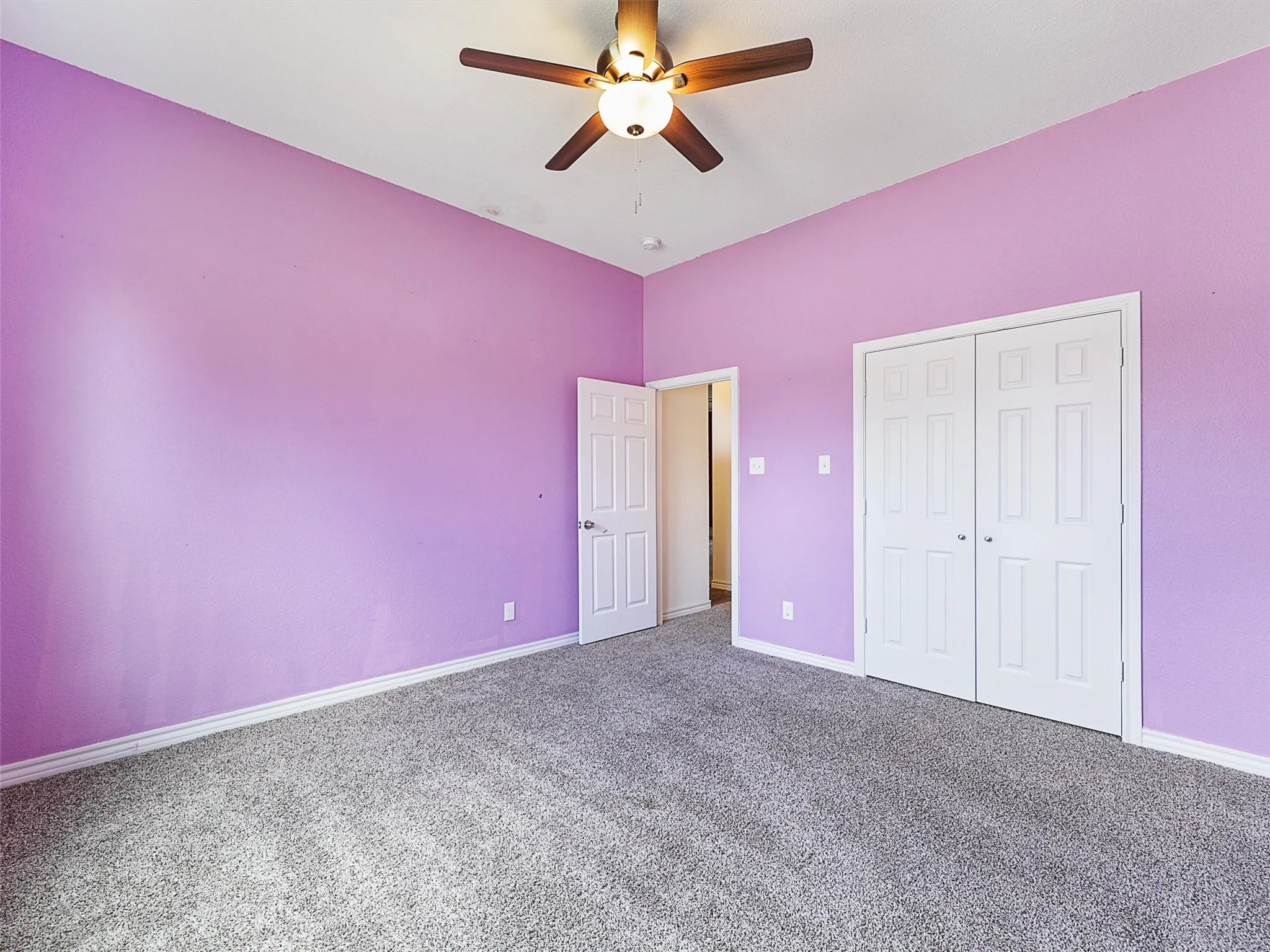 Unfurnished bedroom with carpet flooring, a ceiling fan, and a closet
