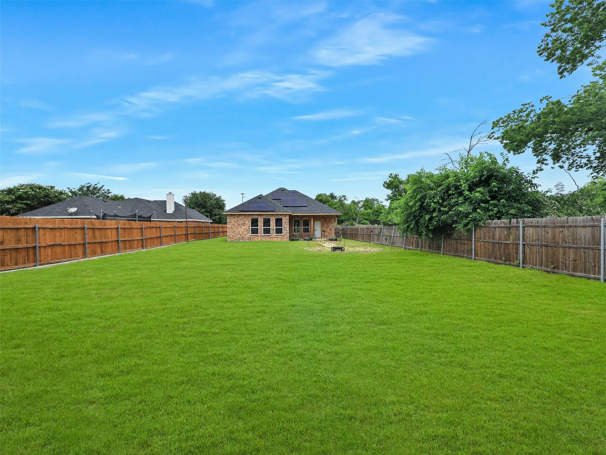 Fenced backyard with a patio area