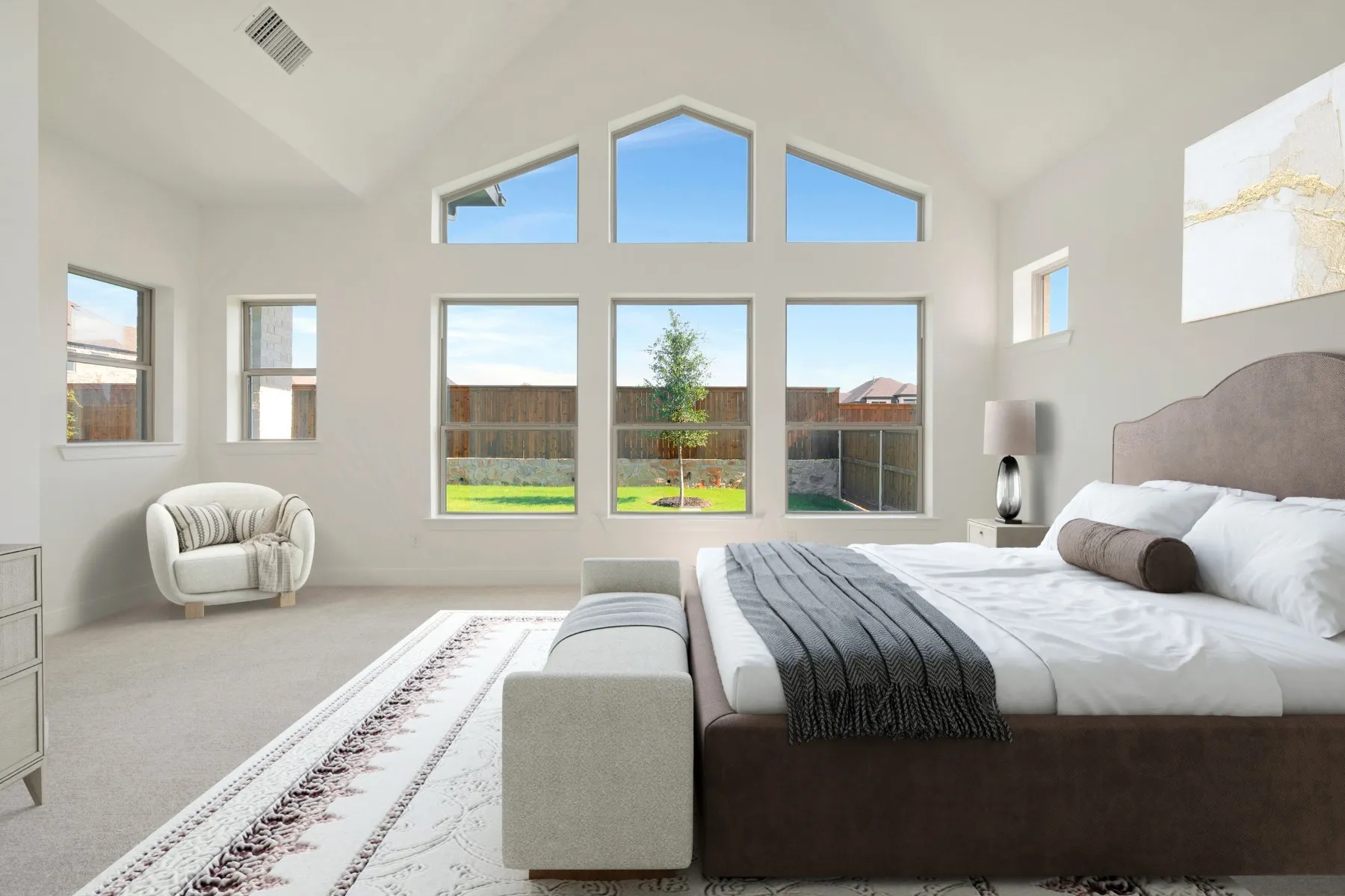 Spacious interior featuring a vaulted ceiling and an array of windows providing abundant natural light