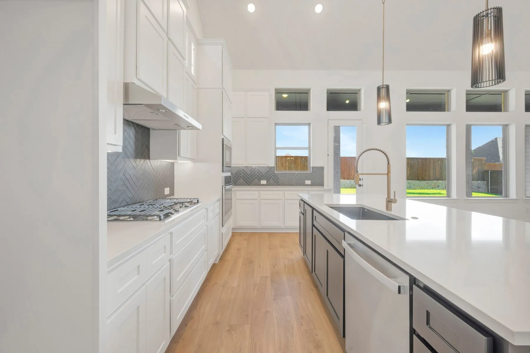 Expansive kitchen island featuring a deep undermount sink and contemporary faucet