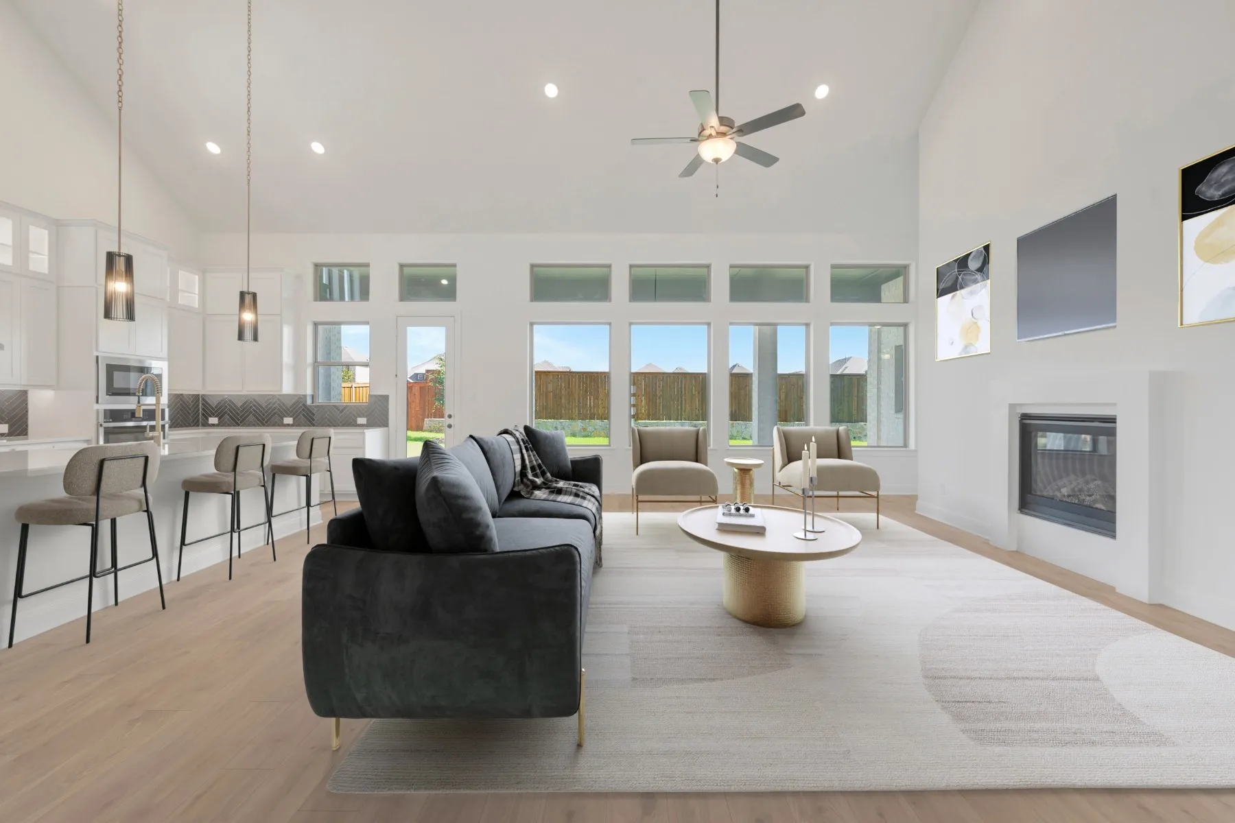 Open-concept living space featuring wood-finish flooring, a contemporary fireplace, and high vaulted ceilings