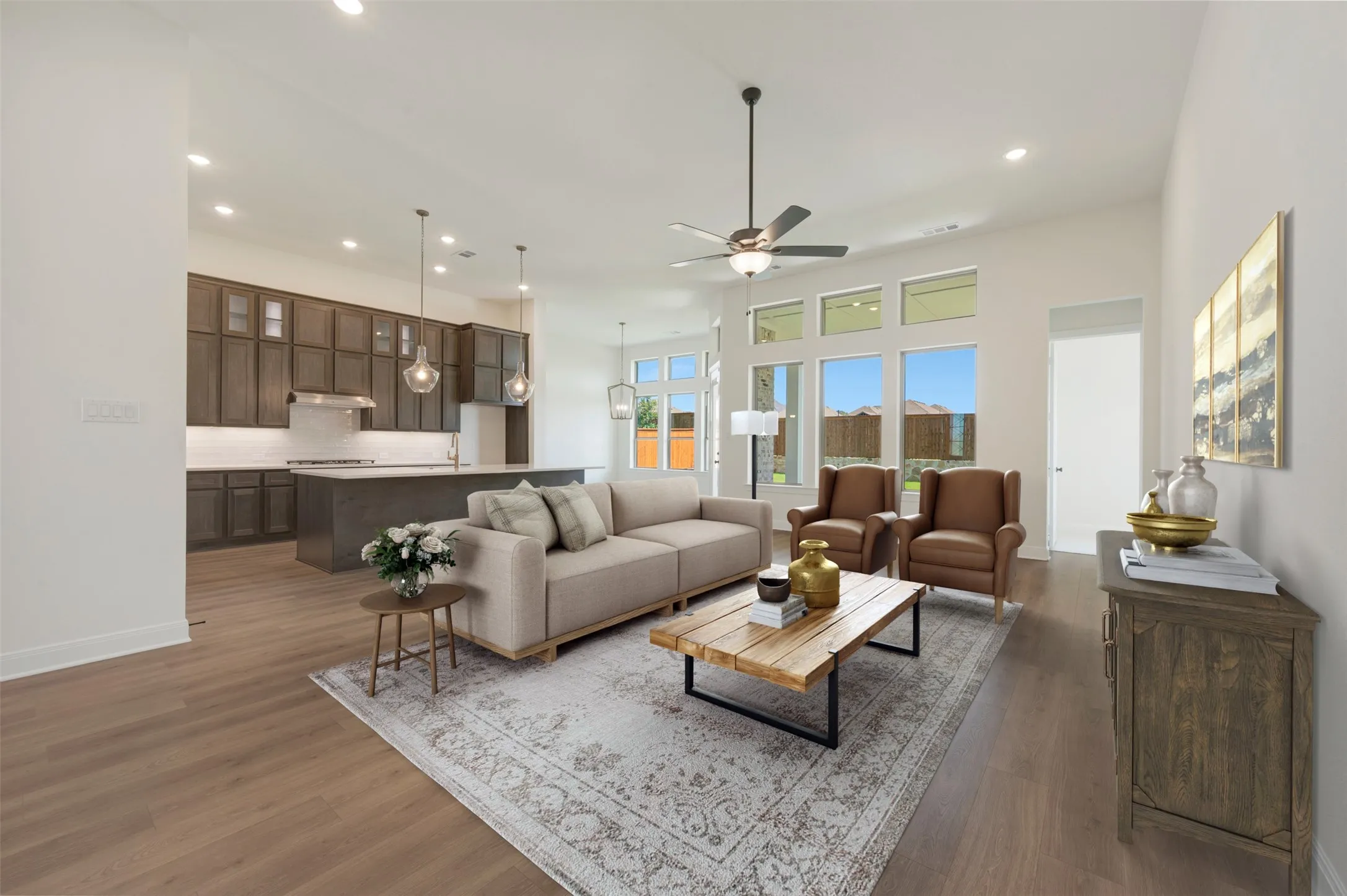 Open-concept living area featuring high ceilings with recessed lighting and a ceiling fan