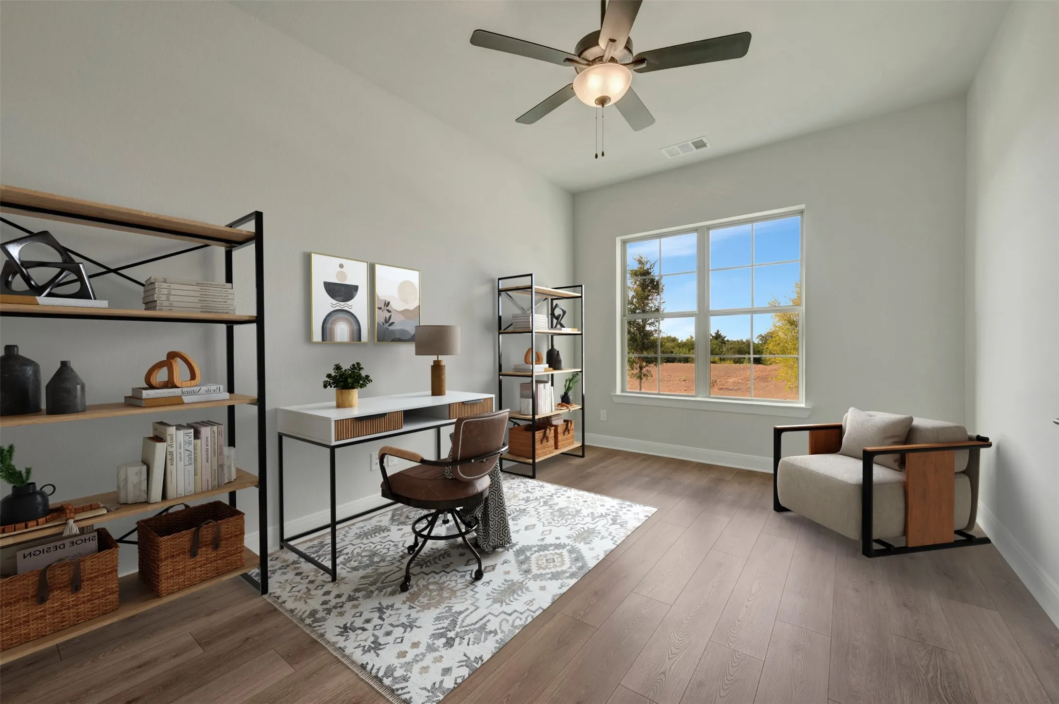 Spacious room featuring wood-finish flooring, a large multi-pane window, and a ceiling fan with integrated lighting