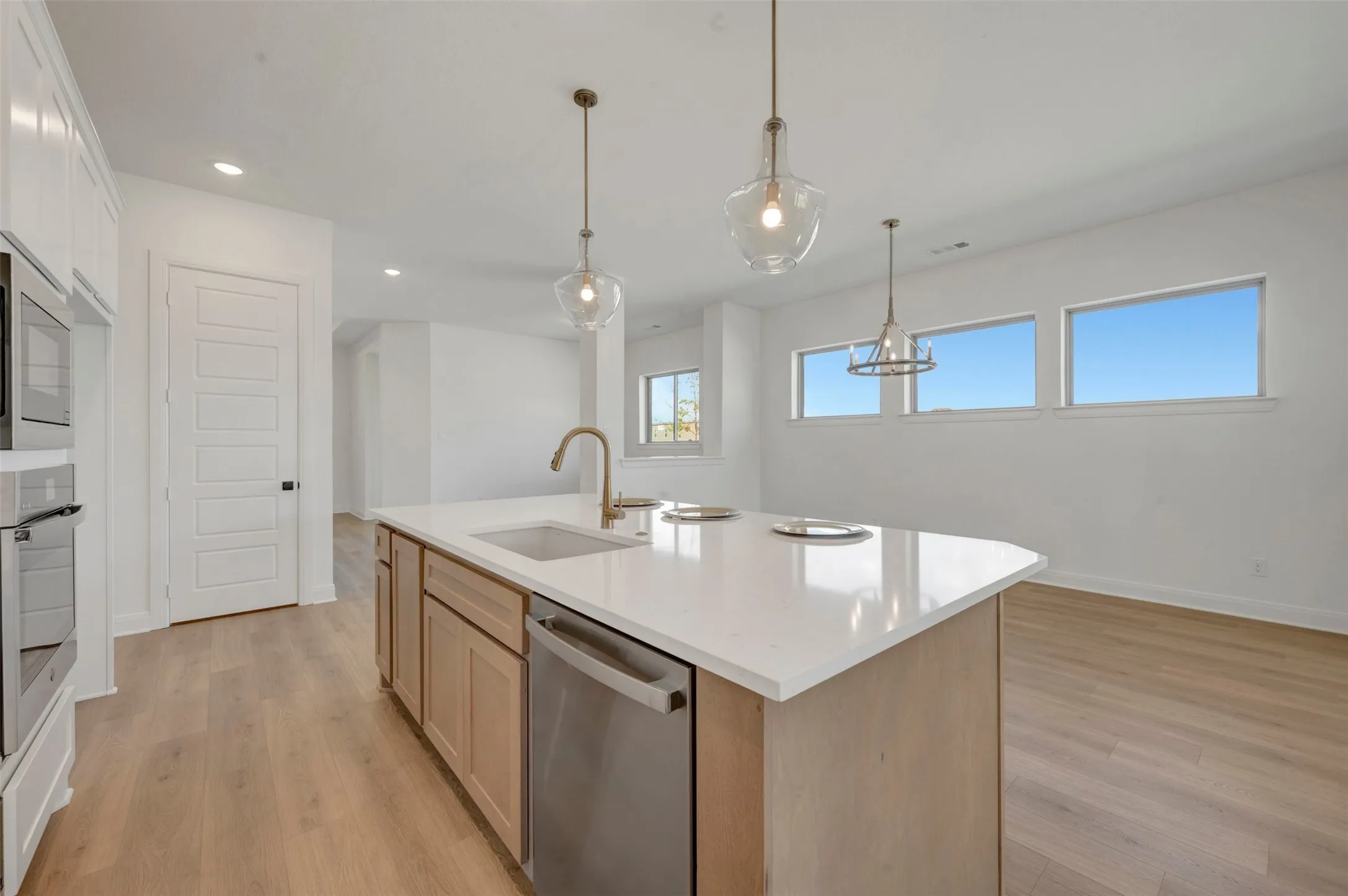 Kitchen island with a built-in sink and stainless steel dishwasher
