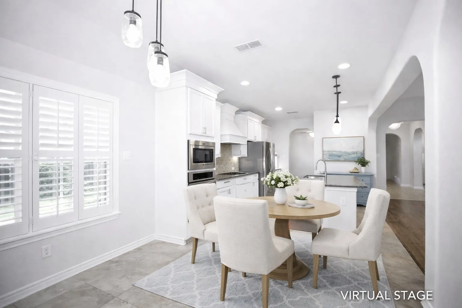 Virtual Staged Dining space featuring arched walkways and recessed lighting