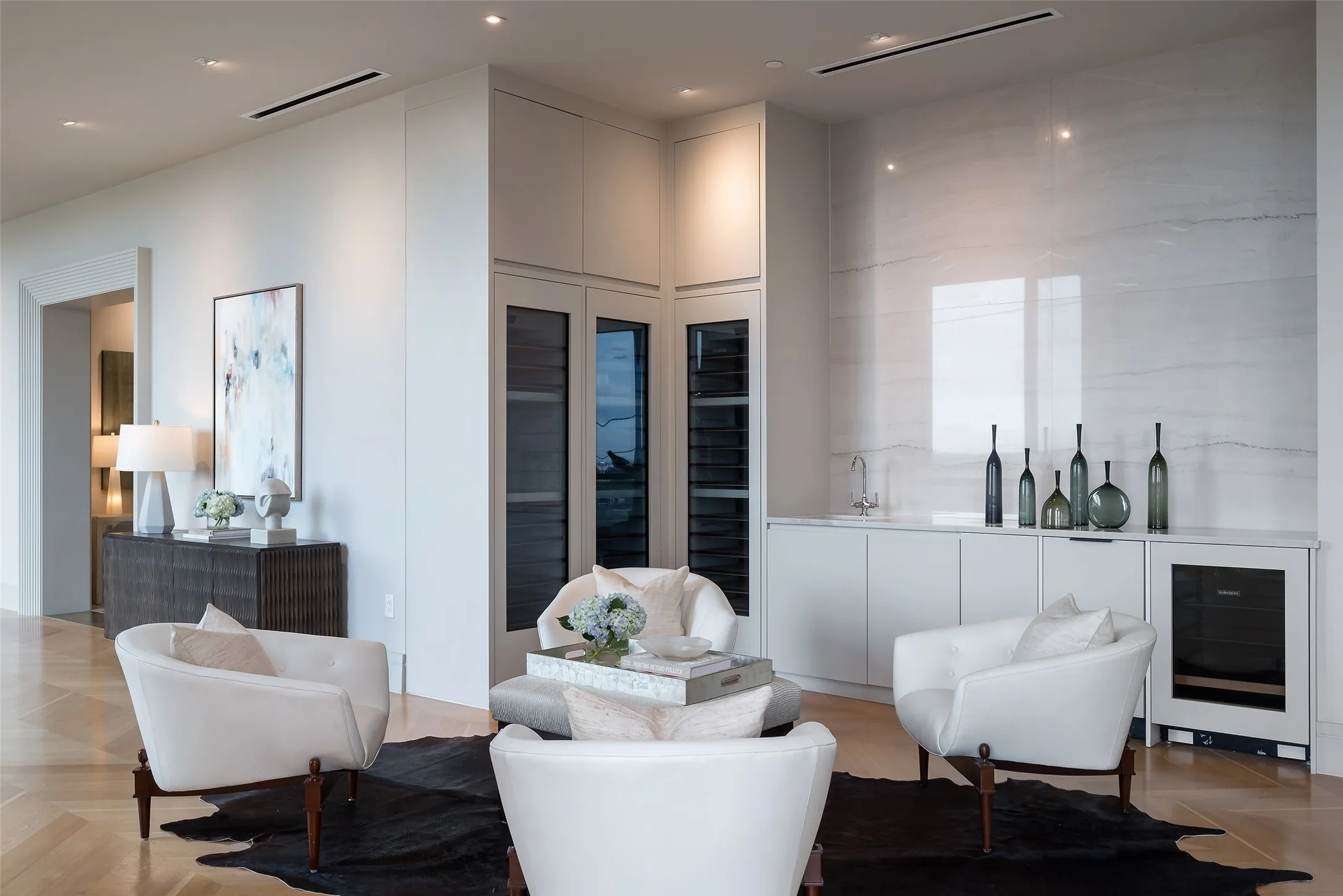 Living area featuring wine cooler, parquet flooring, and a high ceiling