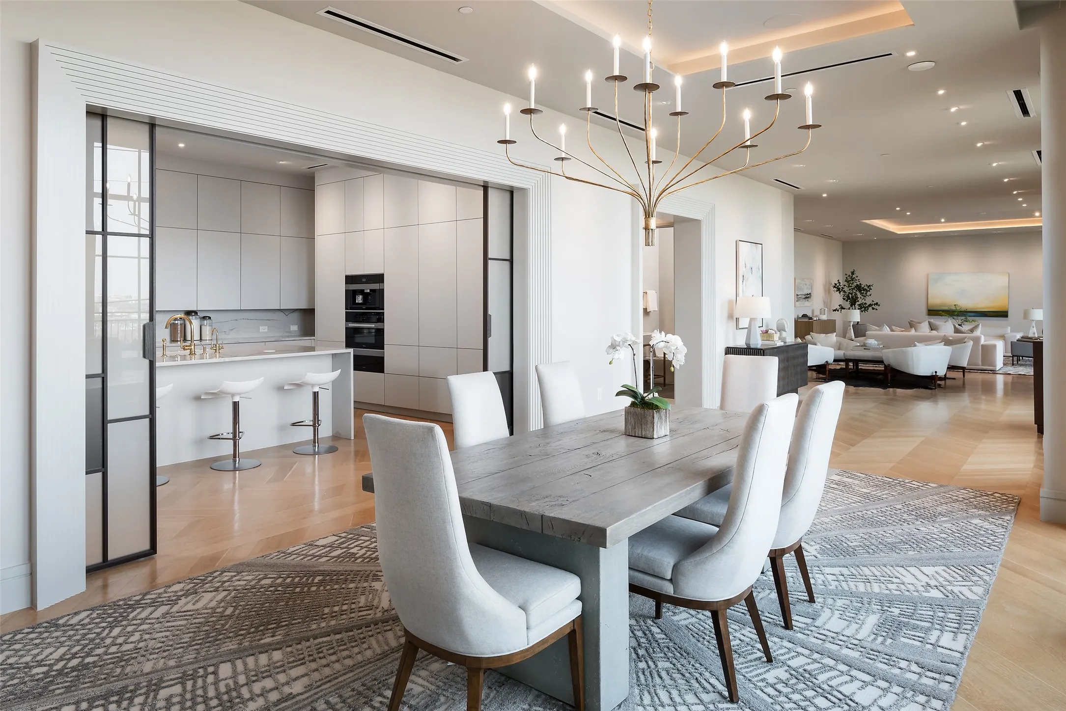 Living area with parquet floors and a tray ceiling
