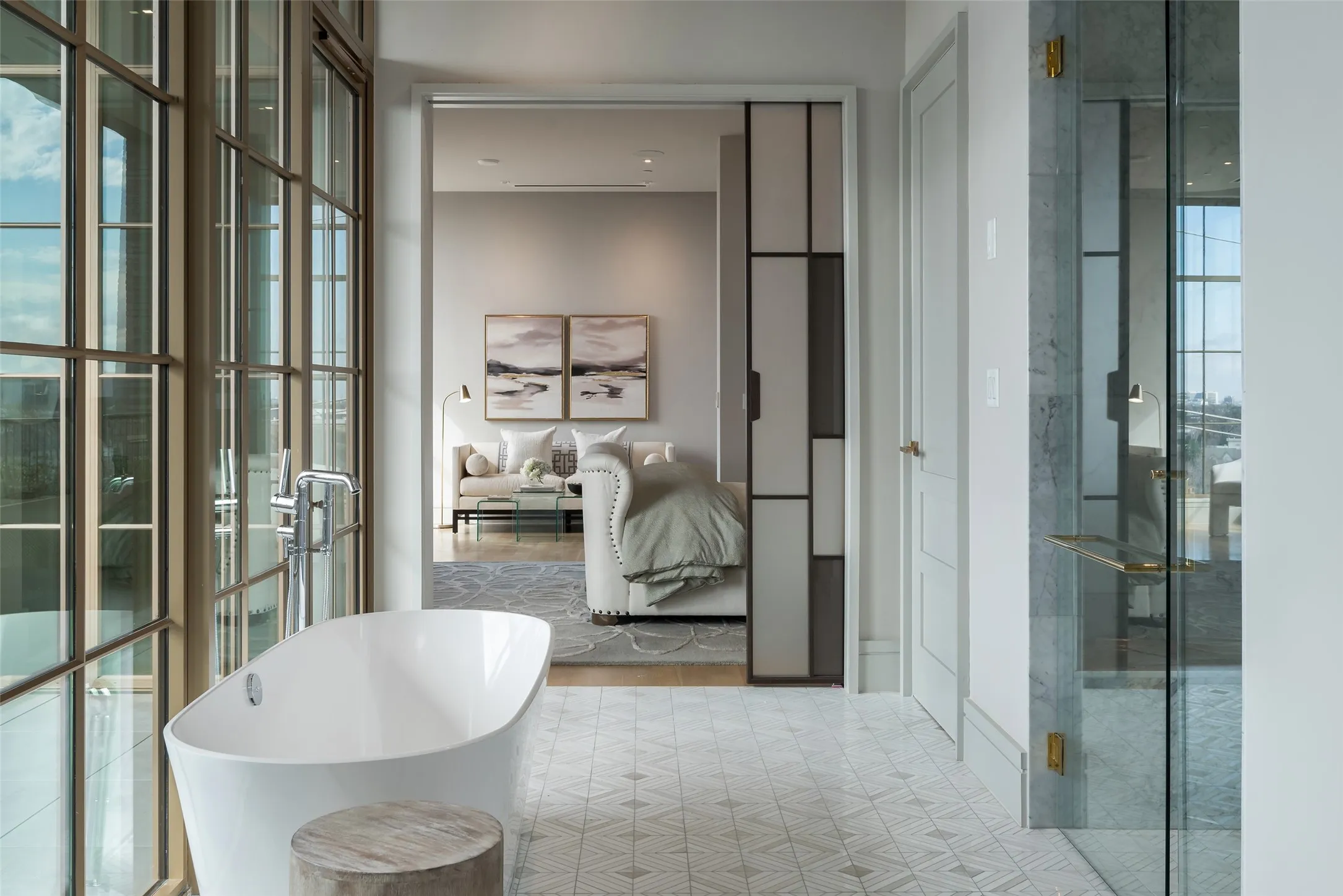 Bathroom featuring a soaking tub, floor to ceiling windows, and a shower stall