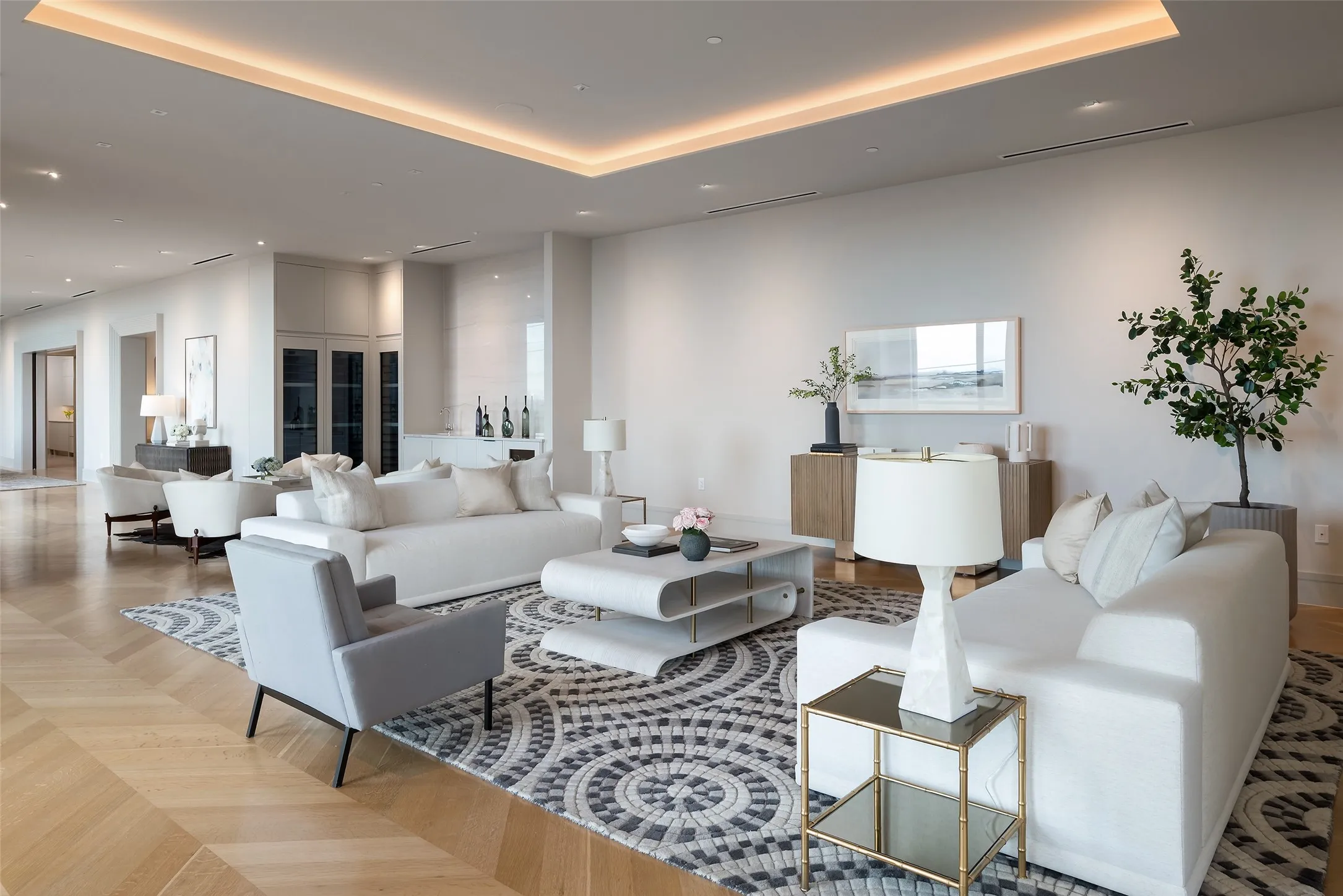 Living room featuring parquet flooring, a tray ceiling, and recessed lighting