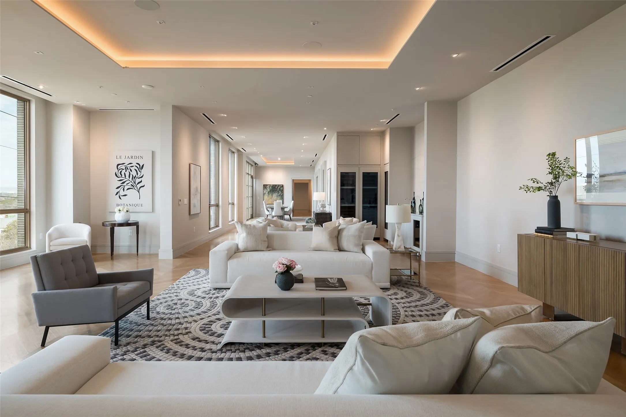Living area with parquet floors and a tray ceiling