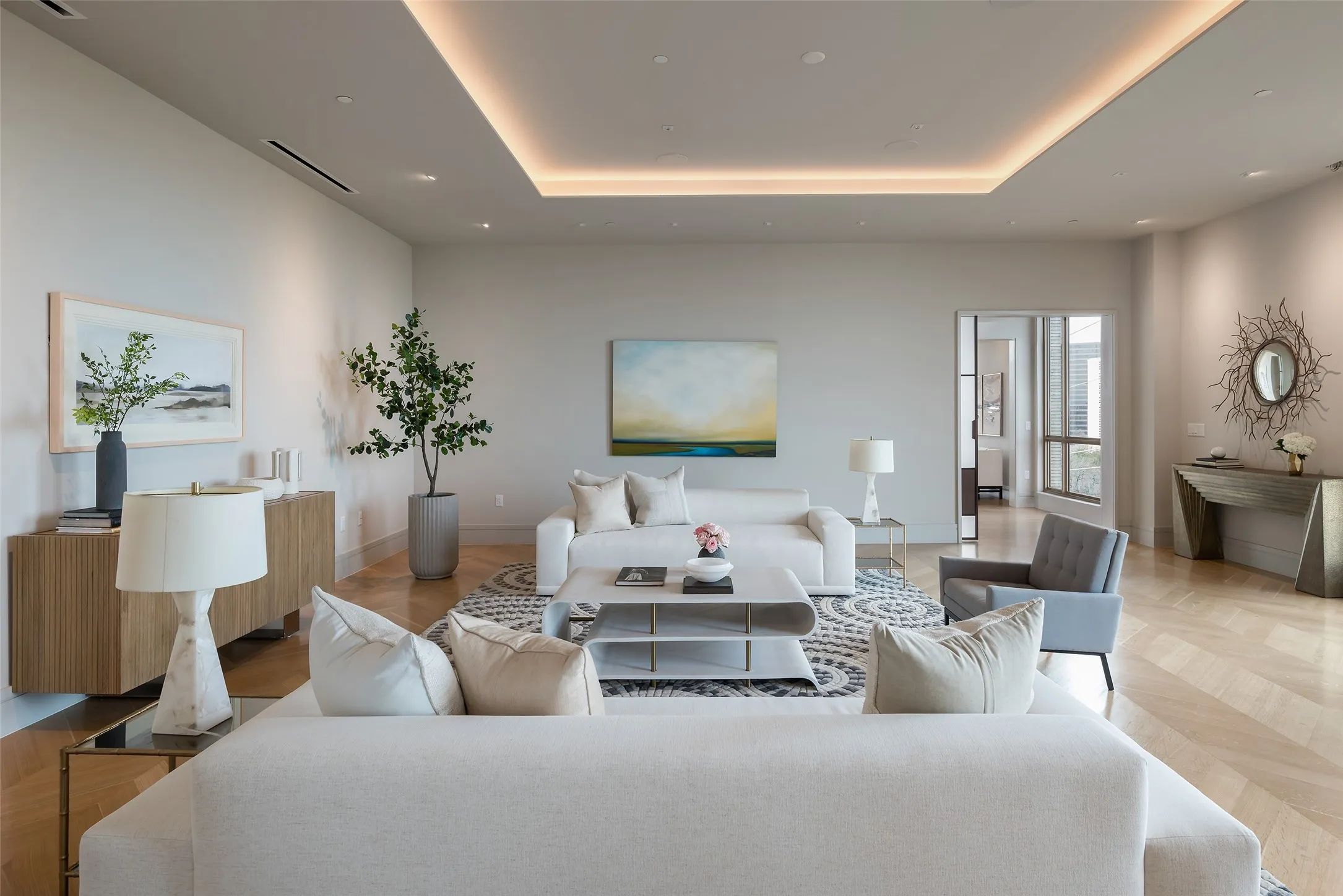 Living area with a raised ceiling and parquet floors