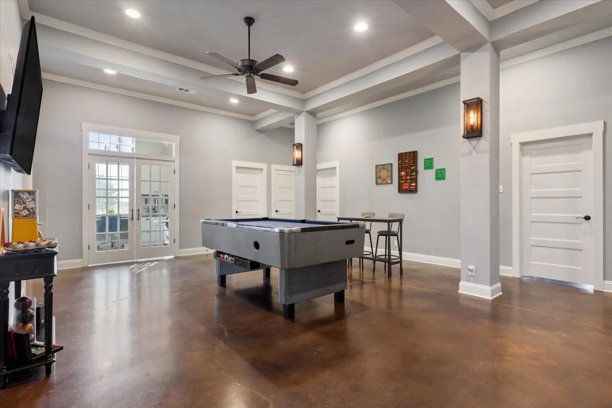 Recreation room with concrete flooring, a ceiling fan, recessed lighting, french doors, and billiards