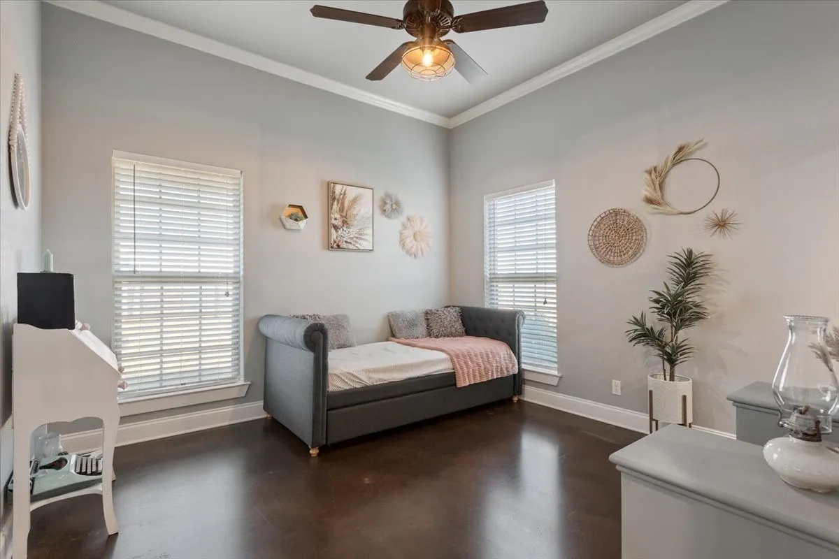 Bedroom with crown molding and a ceiling fan