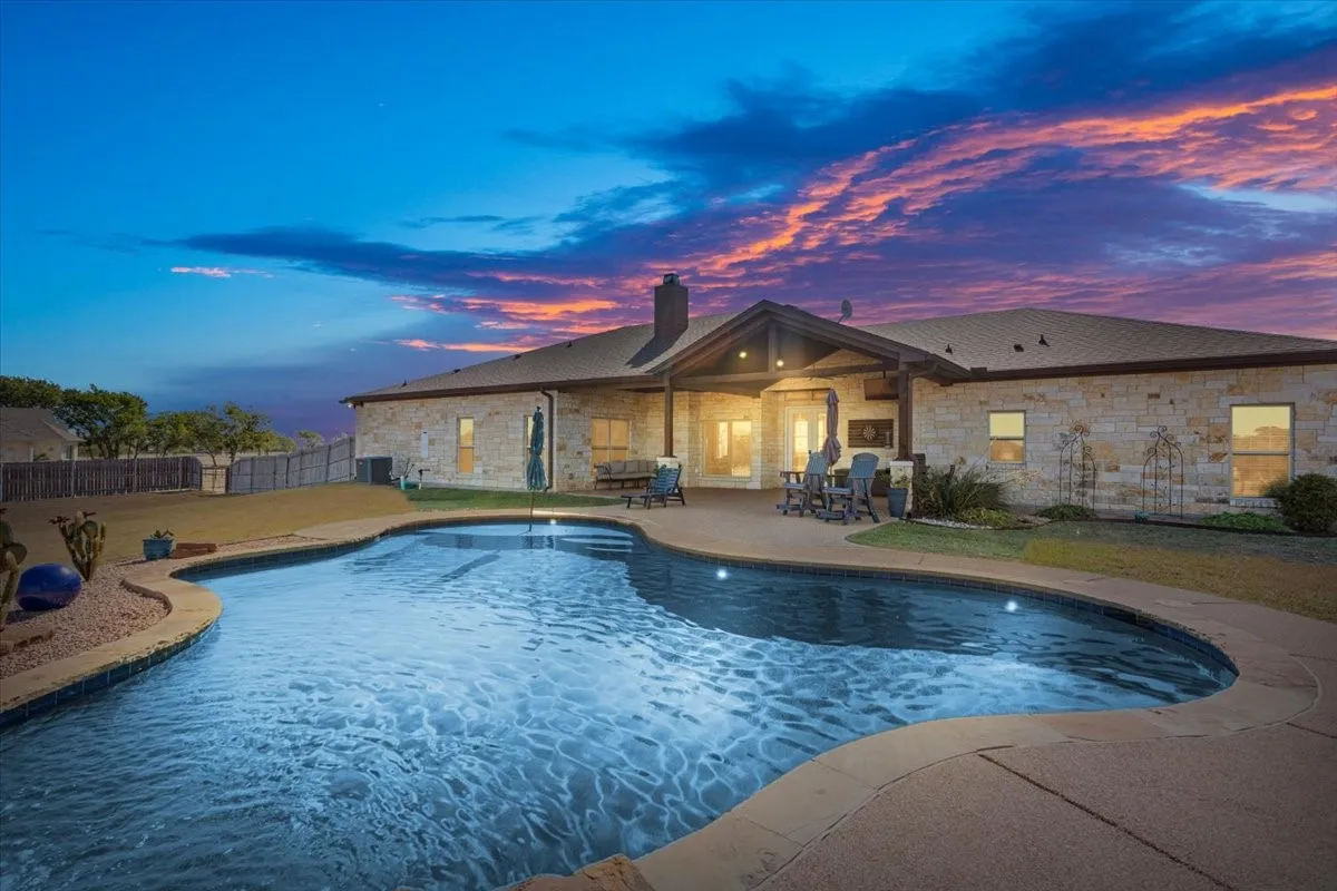 View of pool with patio surround and a fenced backyard