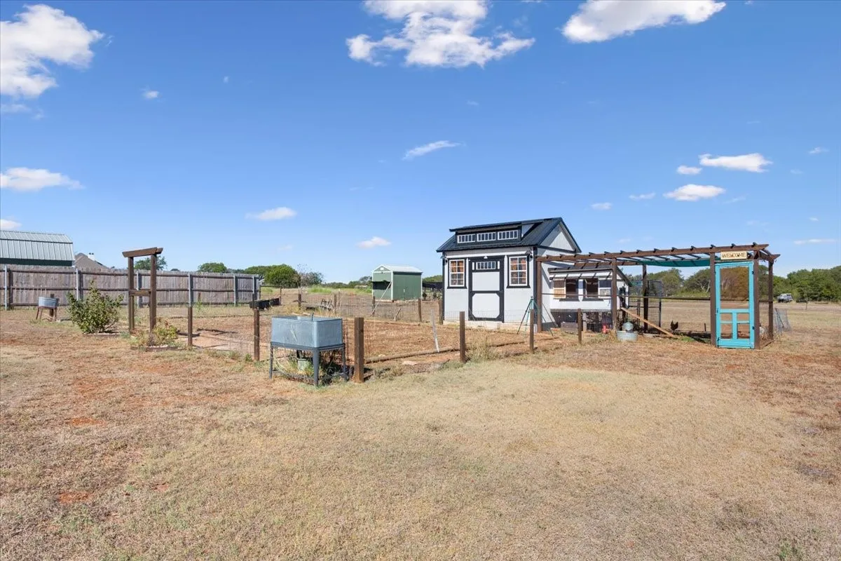 View of yard featuring an outdoor structure and exterior structure
