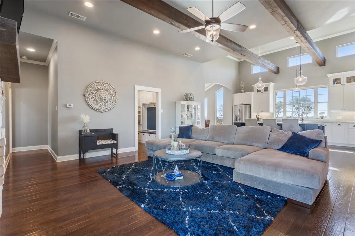 Living area featuring a ceiling fan, dark wood-style floors, arched walkways, and recessed lighting
