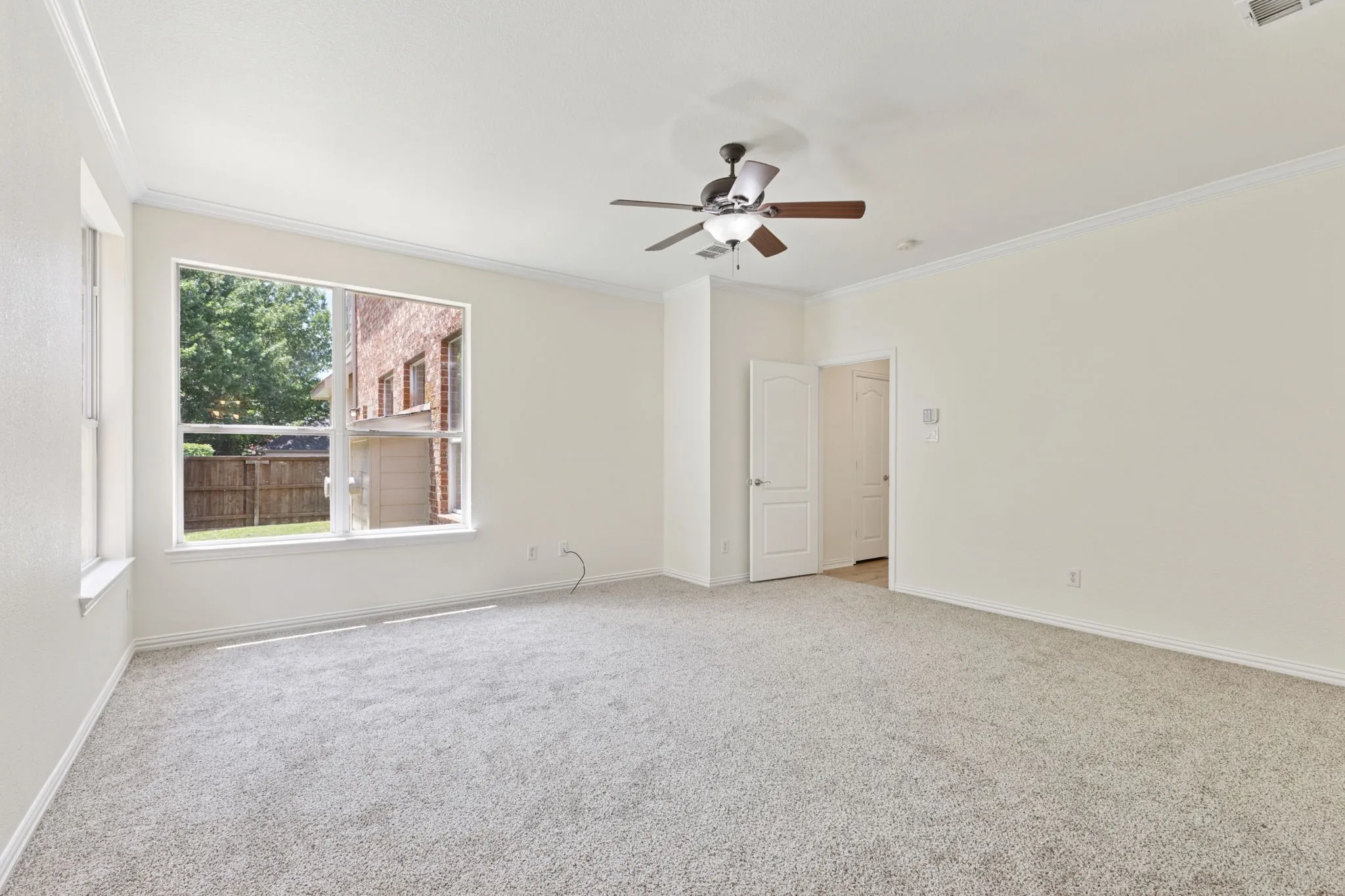 Primary bedroom located downstairs with back yard views. Plenty of windows to let the light shine in.
