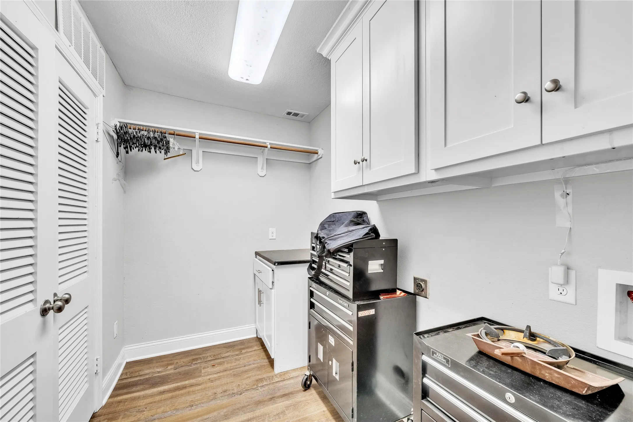 Laundry room featuring folding table and tons of storage