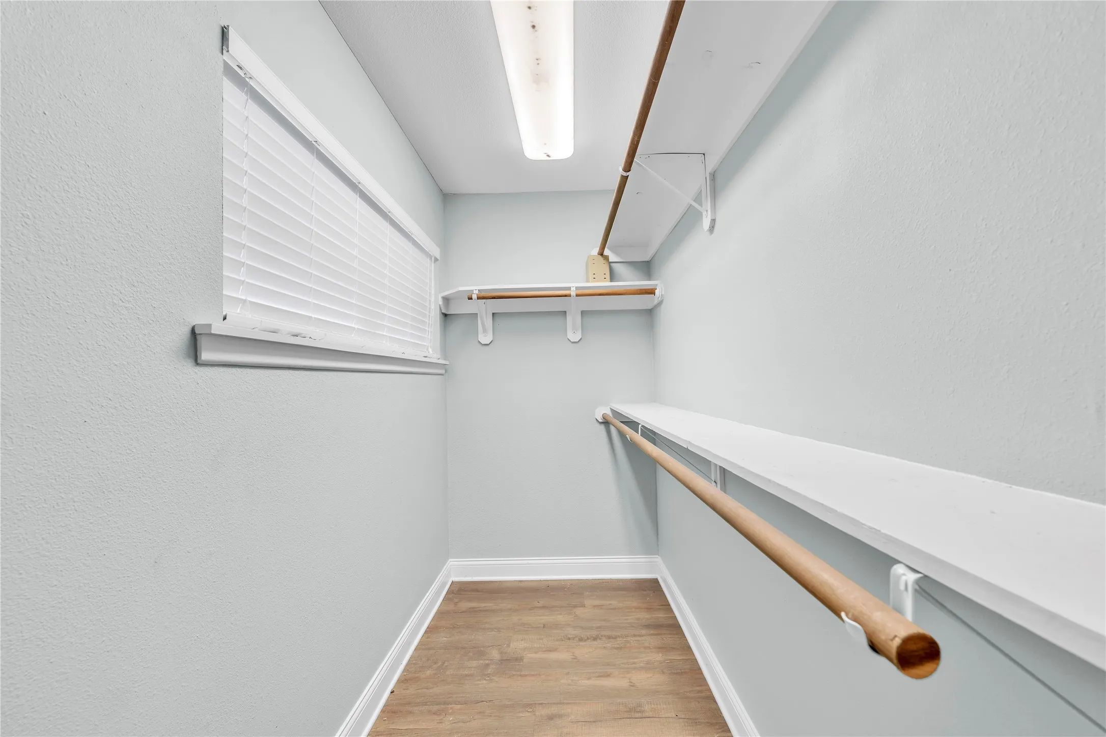 Walk in closet featuring light wood-style flooring
