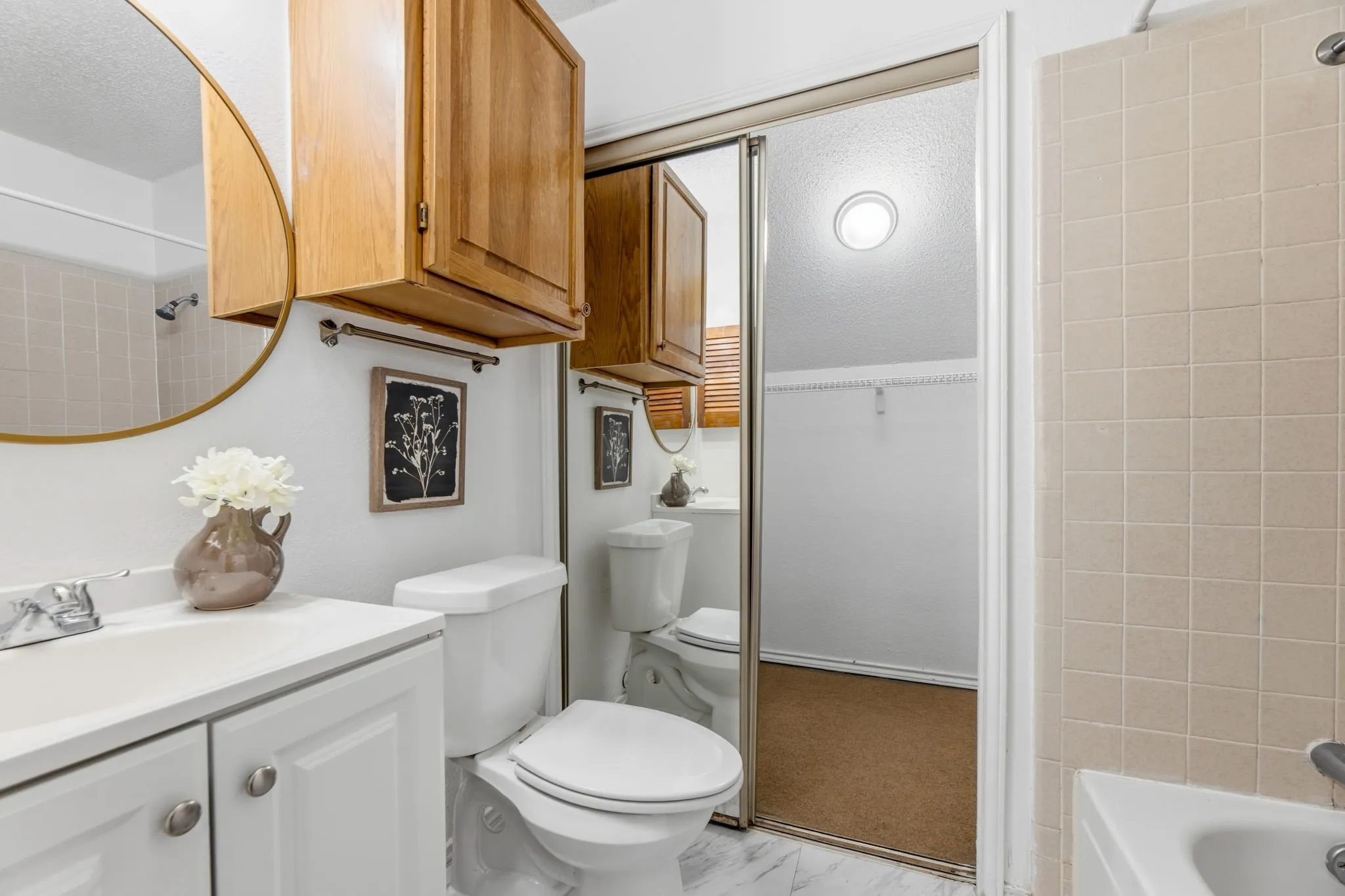 Full bathroom featuring a walk in closet, vanity, and shower / bathtub combination