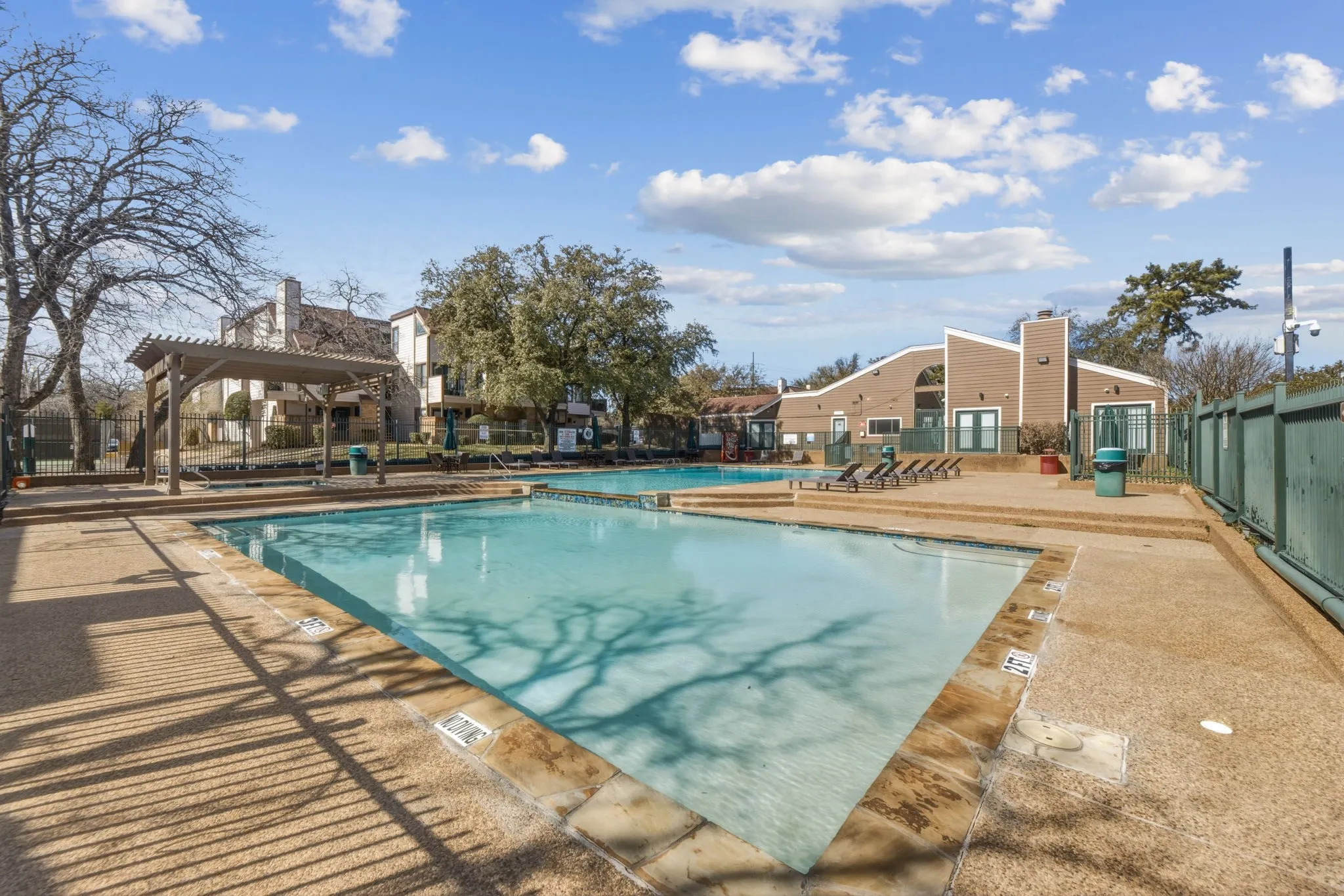 Community pool featuring a patio and a pergola