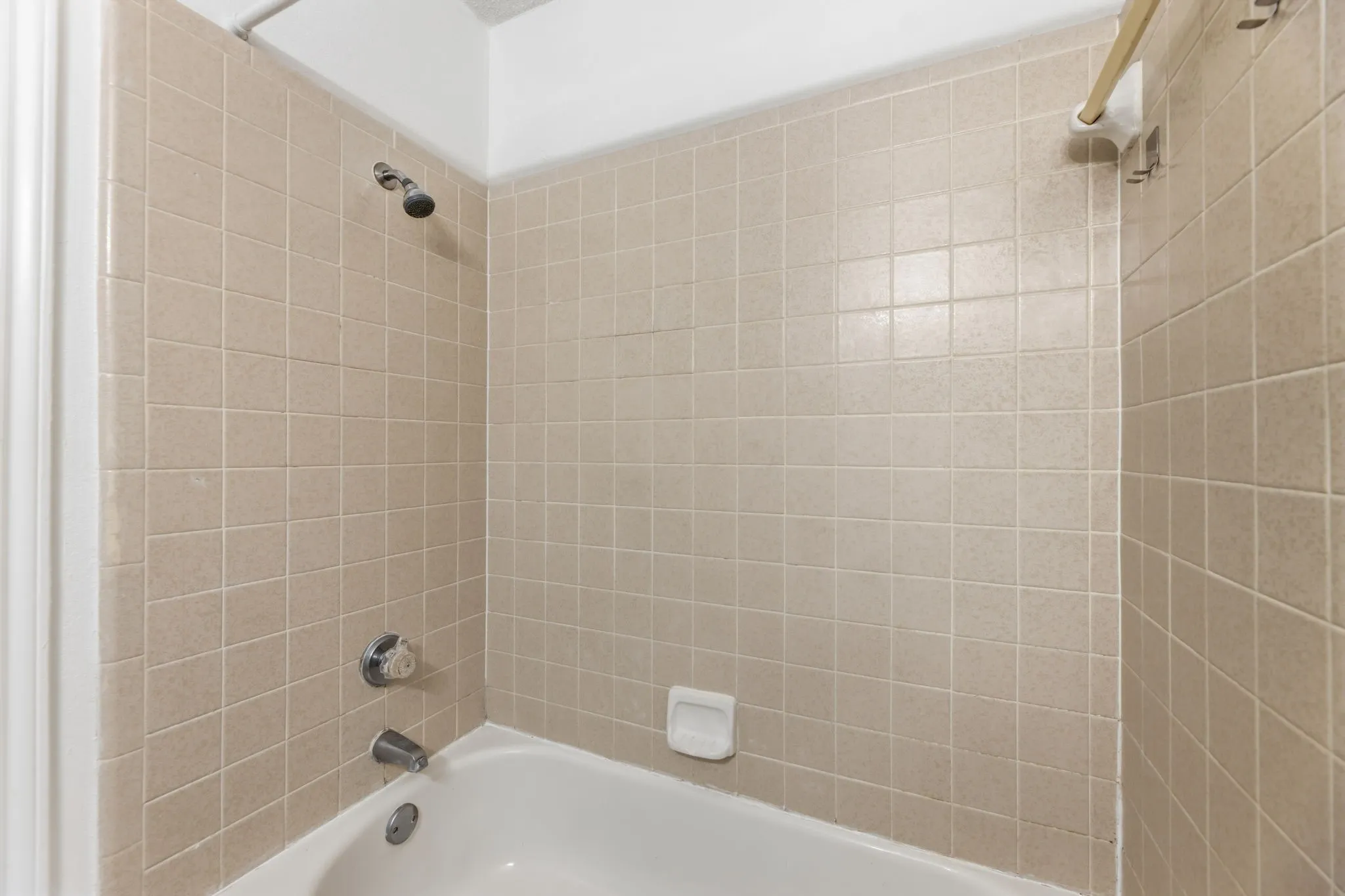 Bathroom featuring washtub / shower combination