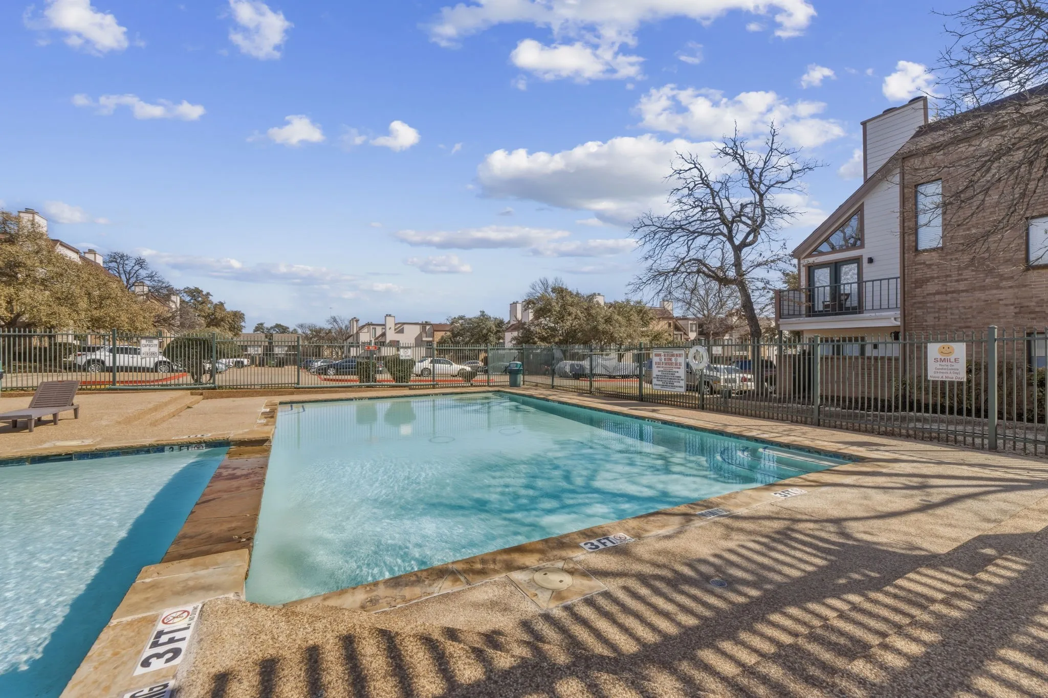 Community pool featuring a patio and a balcony