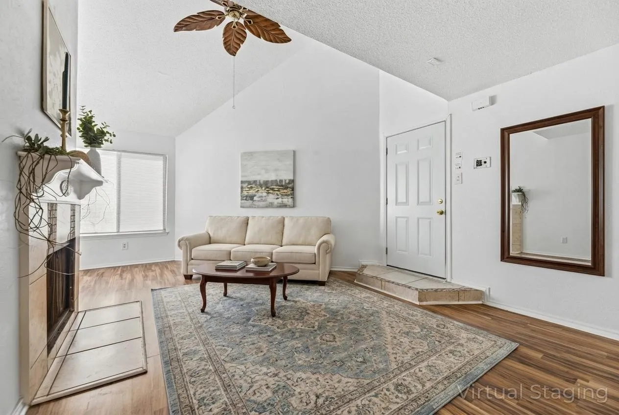 Living room featuring wood finished floors and ceiling fan