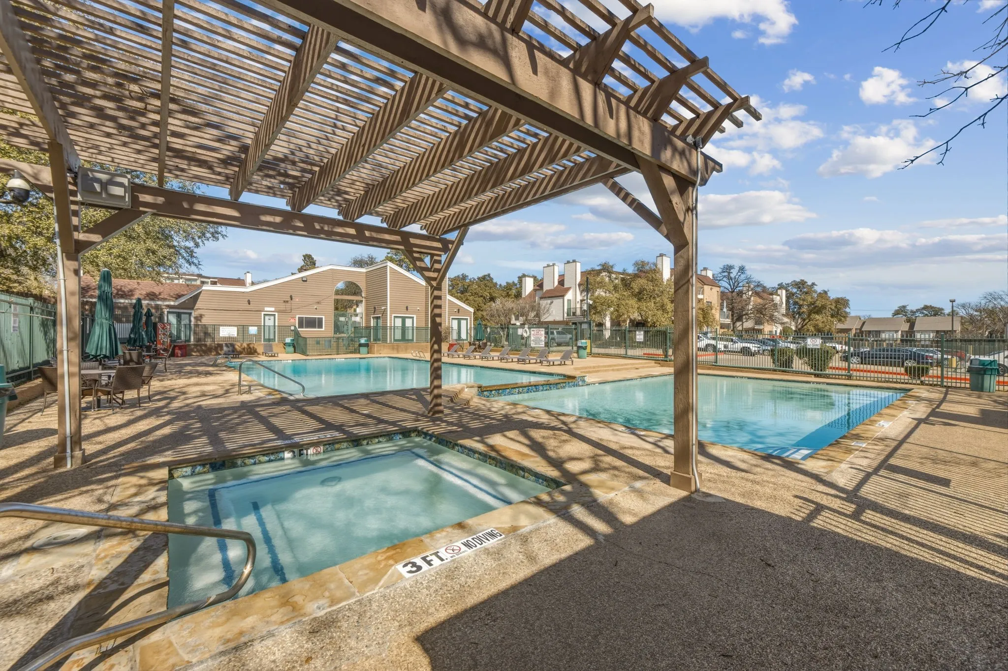 Community pool with a patio area, a pergola, and a community hot tub