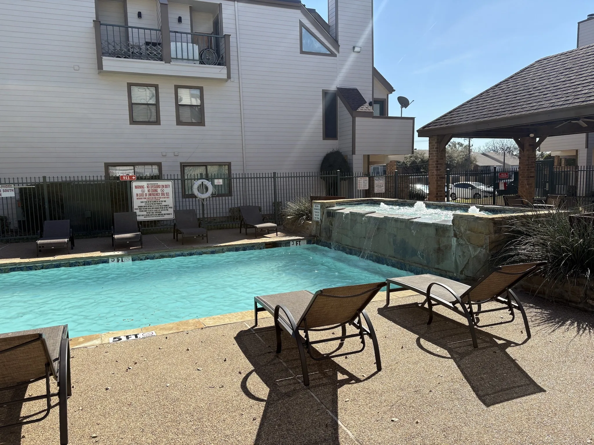 Community pool featuring a patio and a jacuzzi