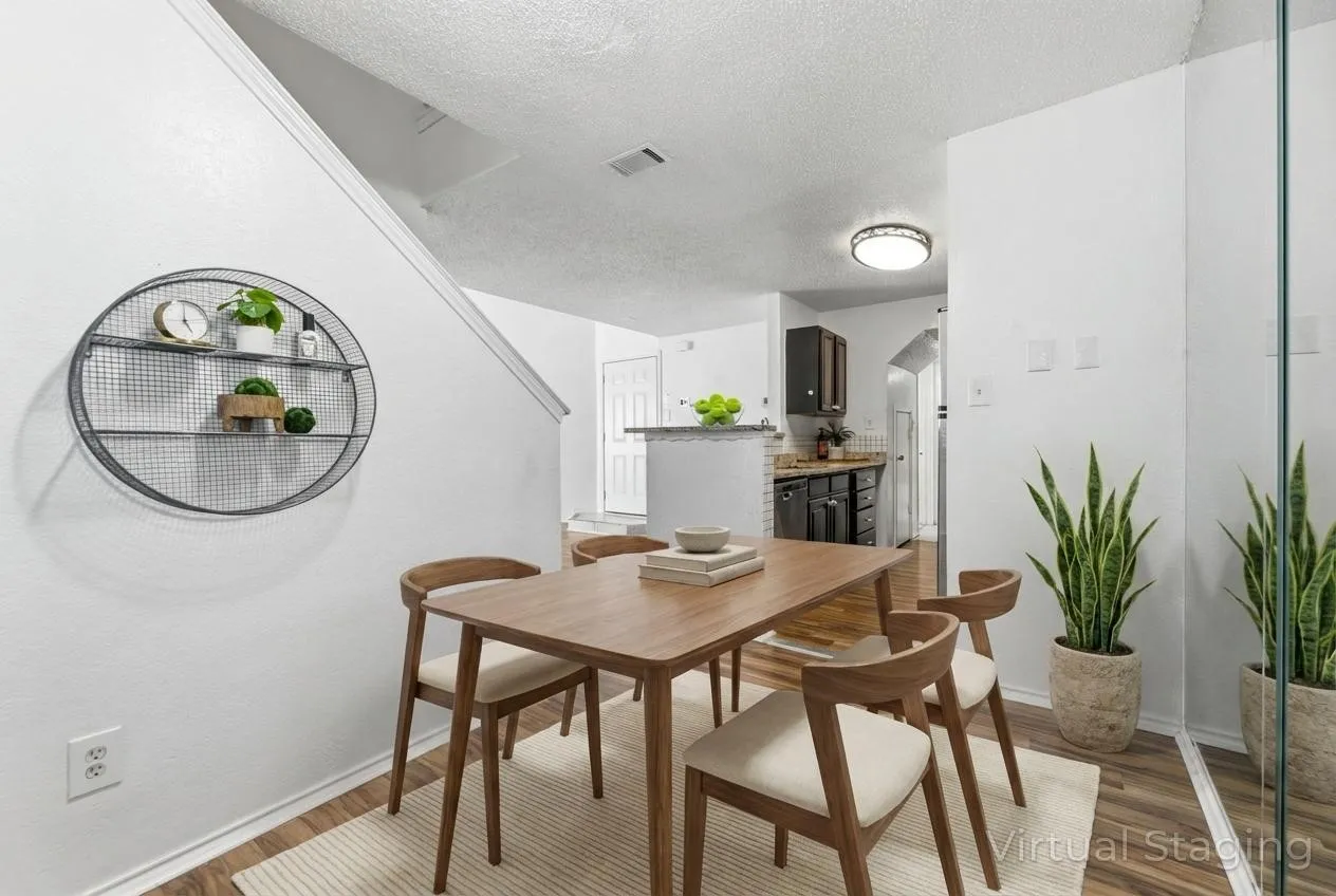 Dining space with wood finished floors and a textured ceiling