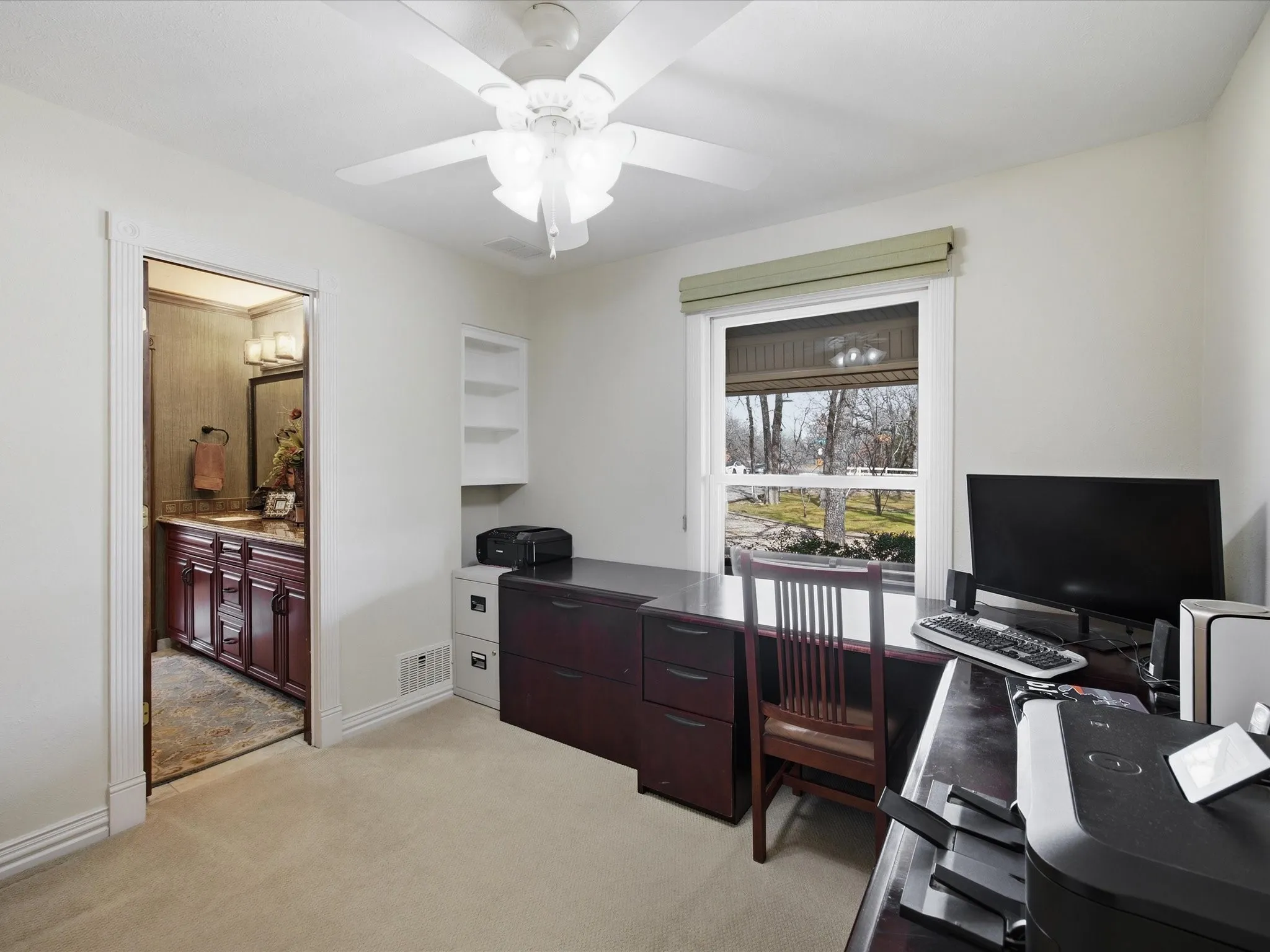 Bedroom featuring light carpet and a ceiling fan