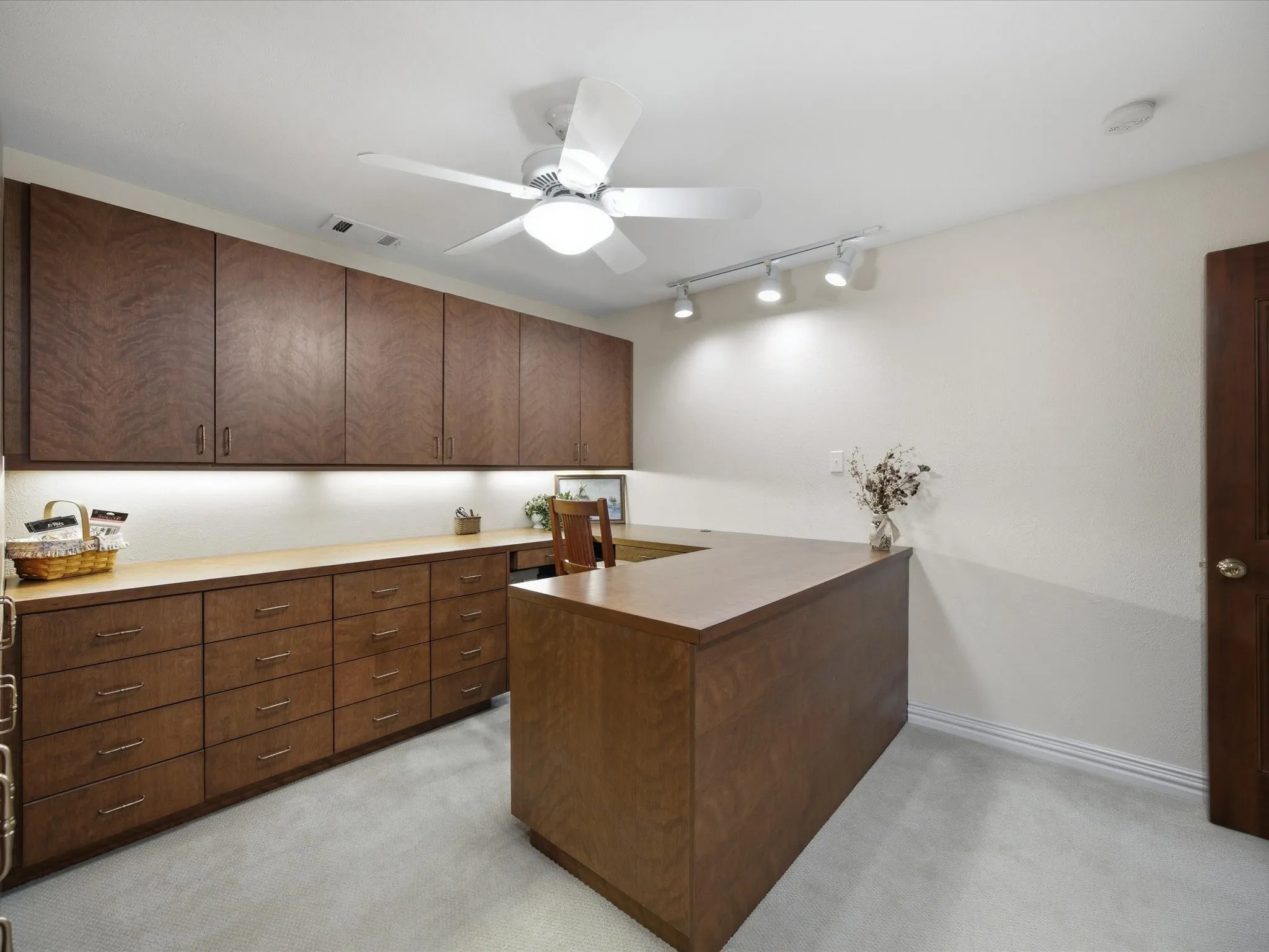 Craft Room with rail lighting, light colored carpet, and ceiling fan