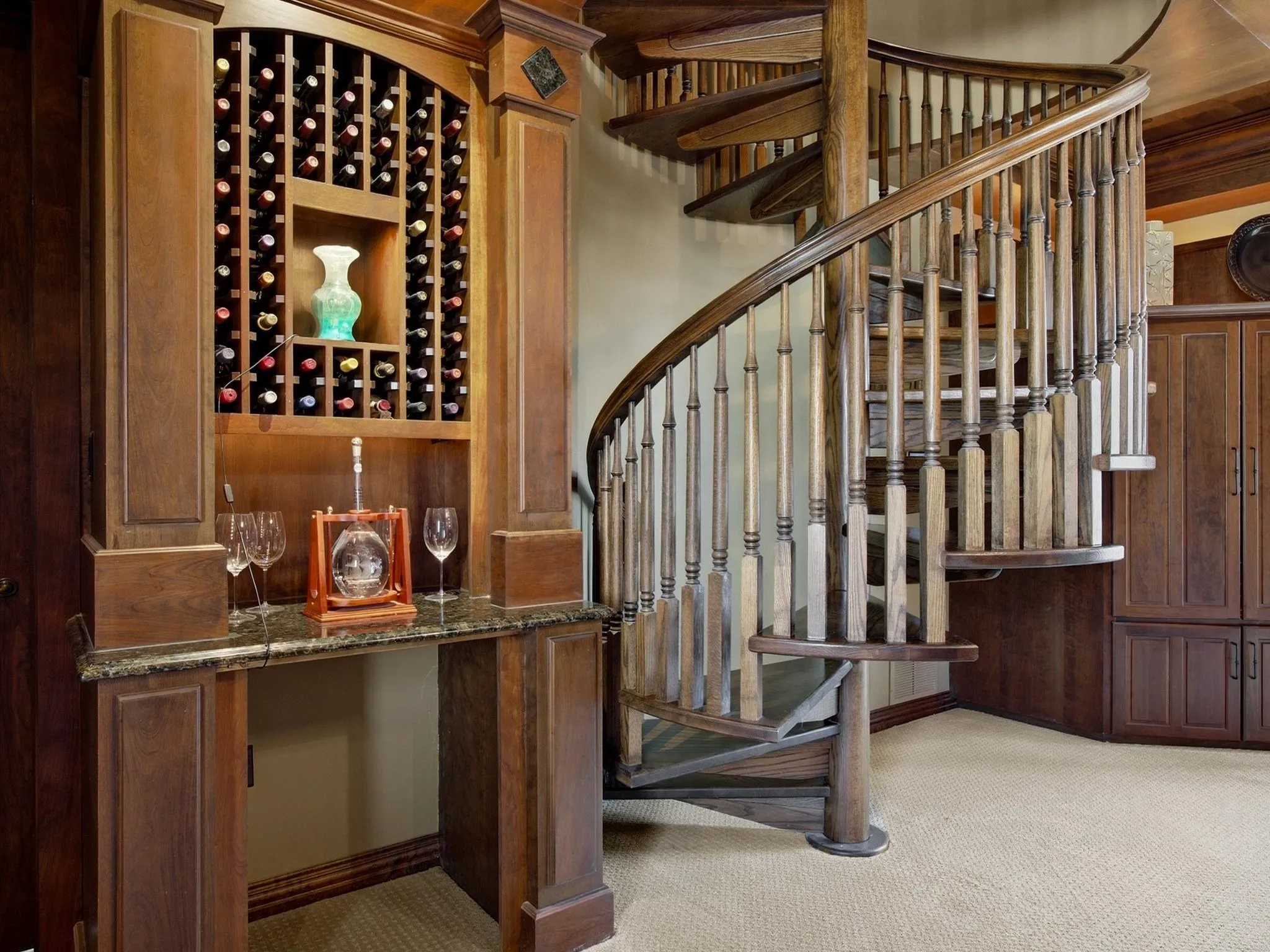 Spiral staircase with dry bar in Library
