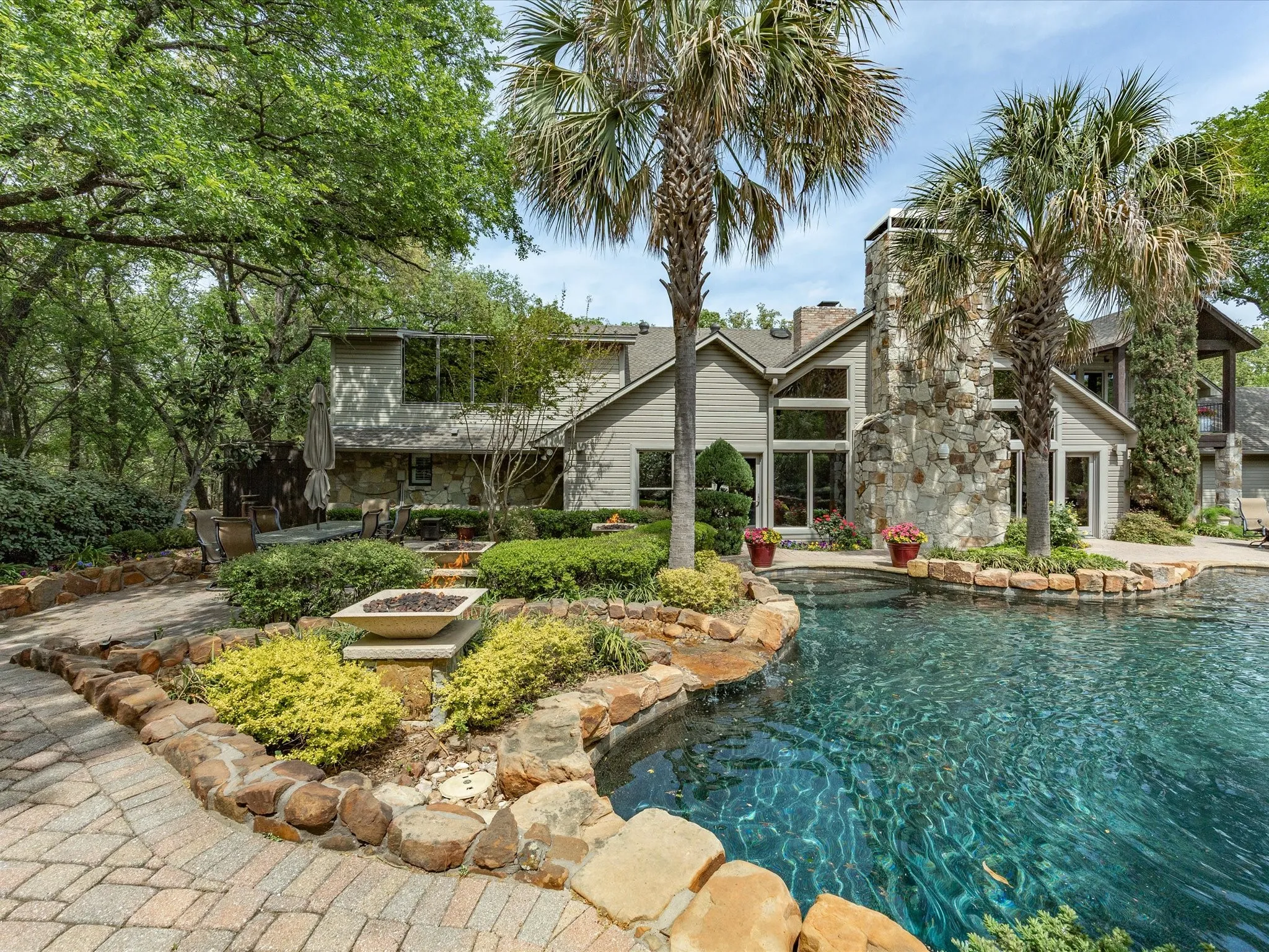 Deep end of pool featuring fire bowls