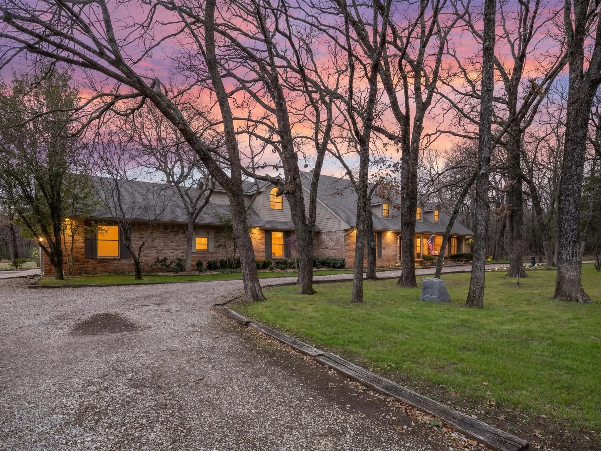 View of front facade featuring a front lawn and brick siding
