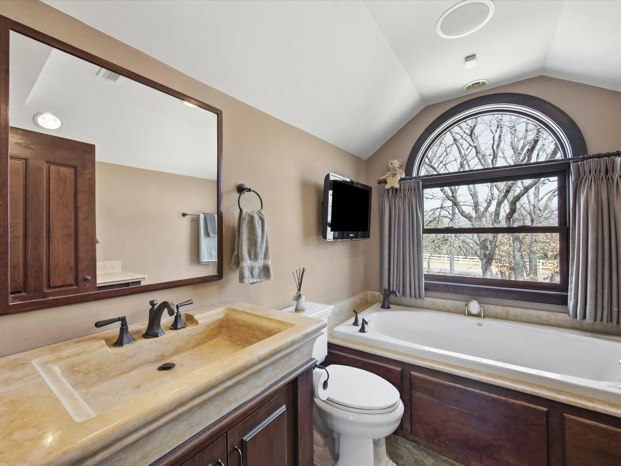 Full bath featuring vanity and a bath