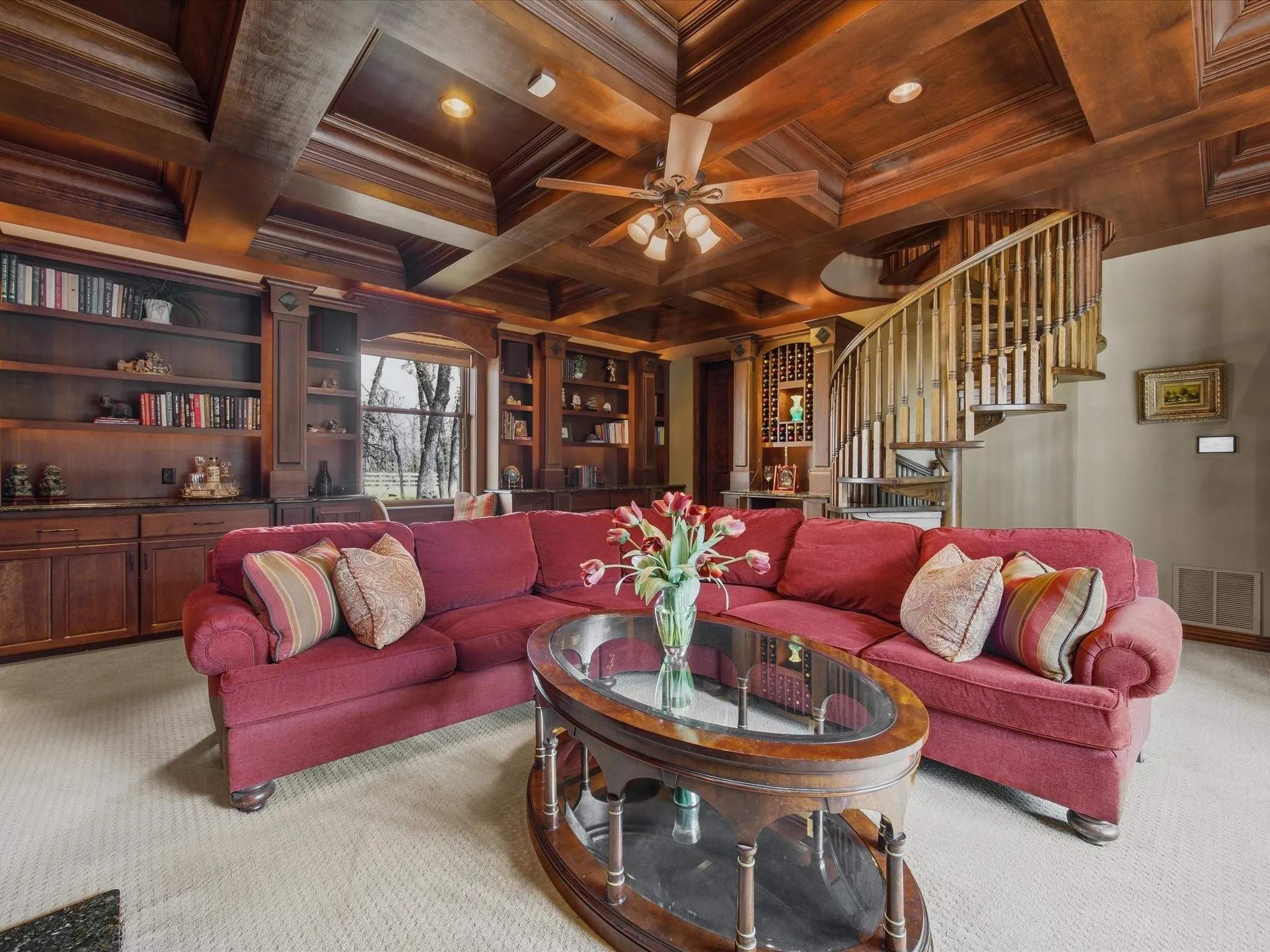 Library with coffered ceiling, wood ceiling, carpet flooring, ceiling fan, and crown molding