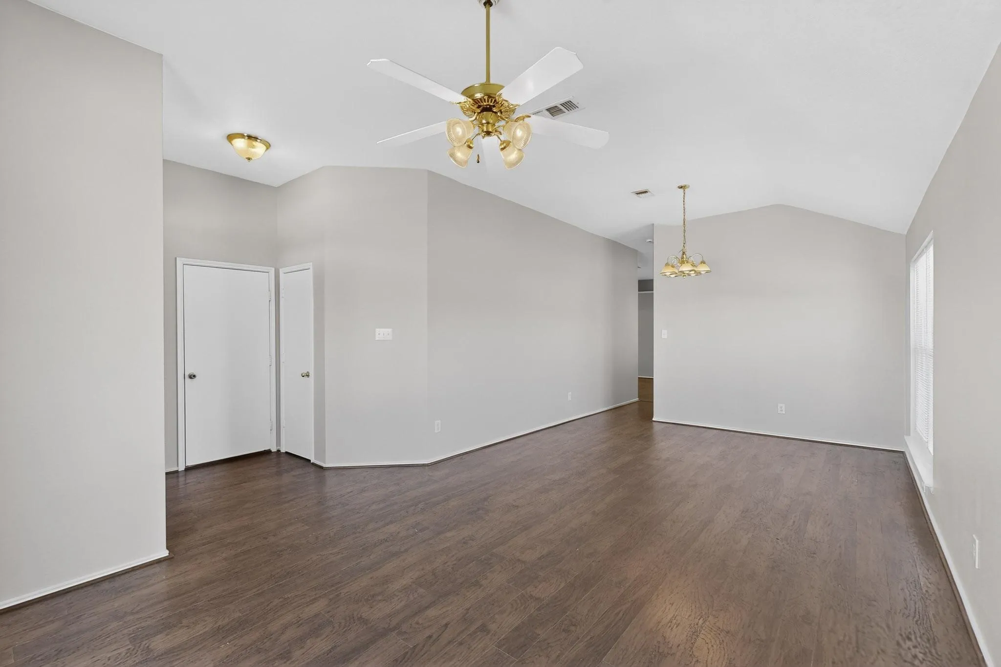 Living view toward garage exit door and coat closet