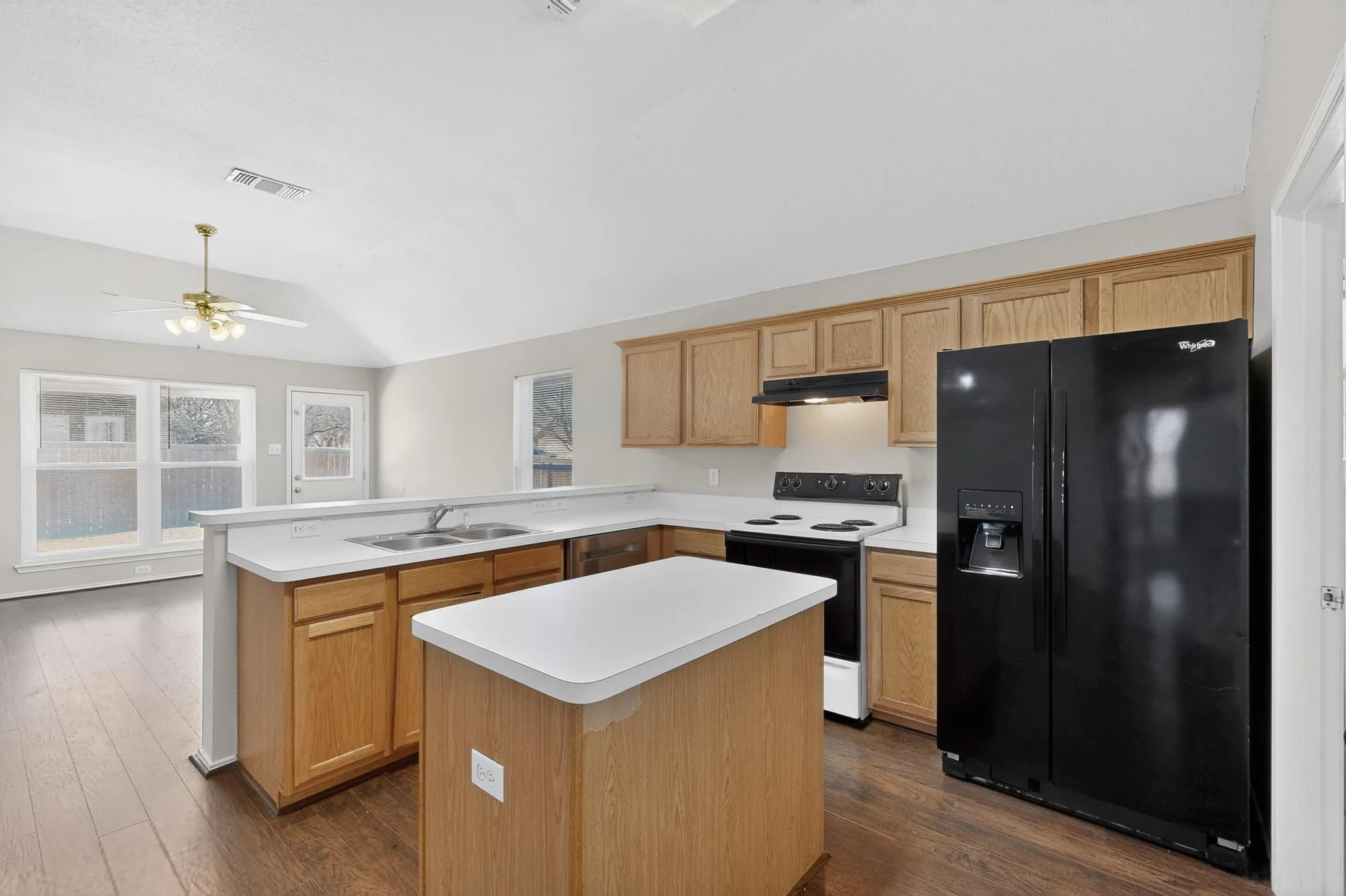 Kitchen with island, fridge, new dishwasher, and lots of cabinets
