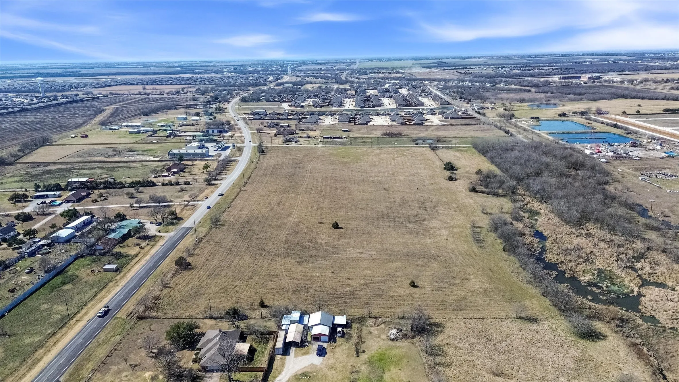Aerial view of property and surrounding area with rural landscape and abundant farmland