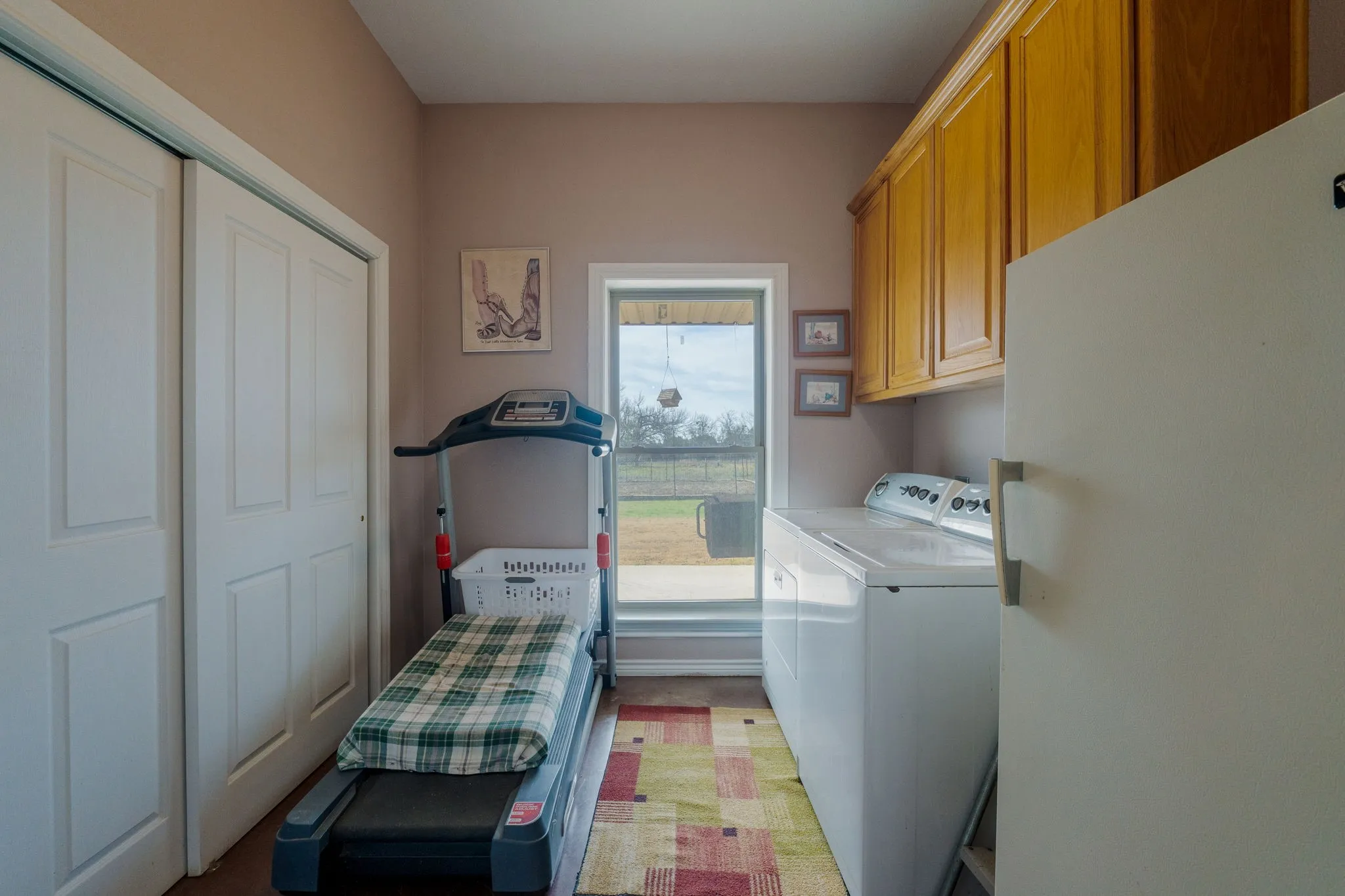 Laundry area featuring cabinet space and washer and clothes dryer