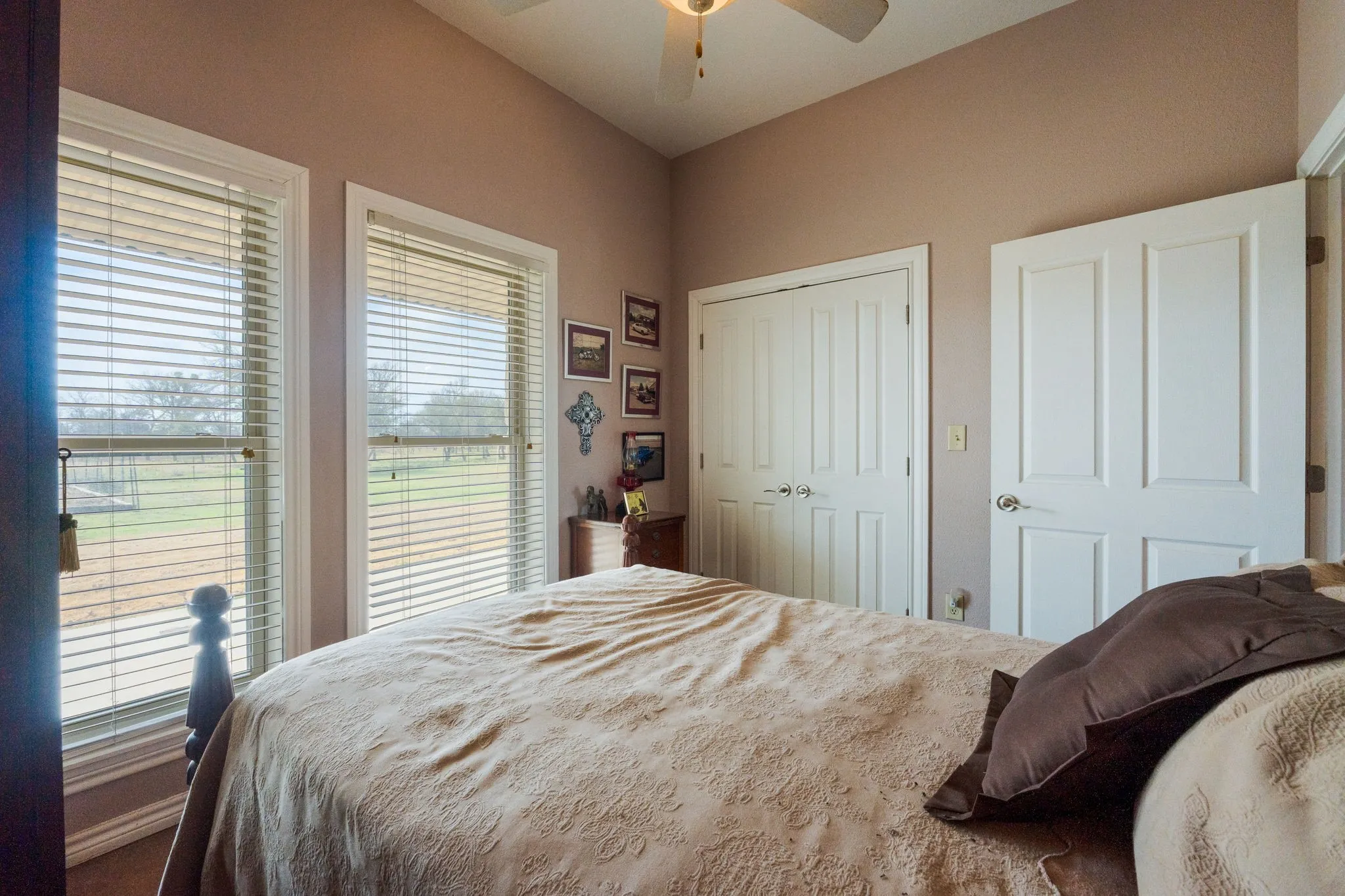 Bedroom with a ceiling fan and a closet