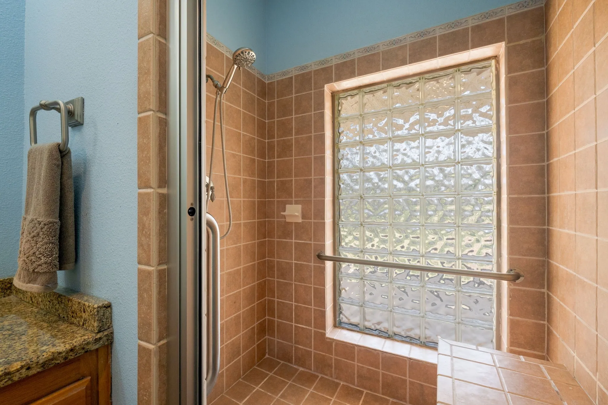 Bathroom featuring a shower stall and vanity