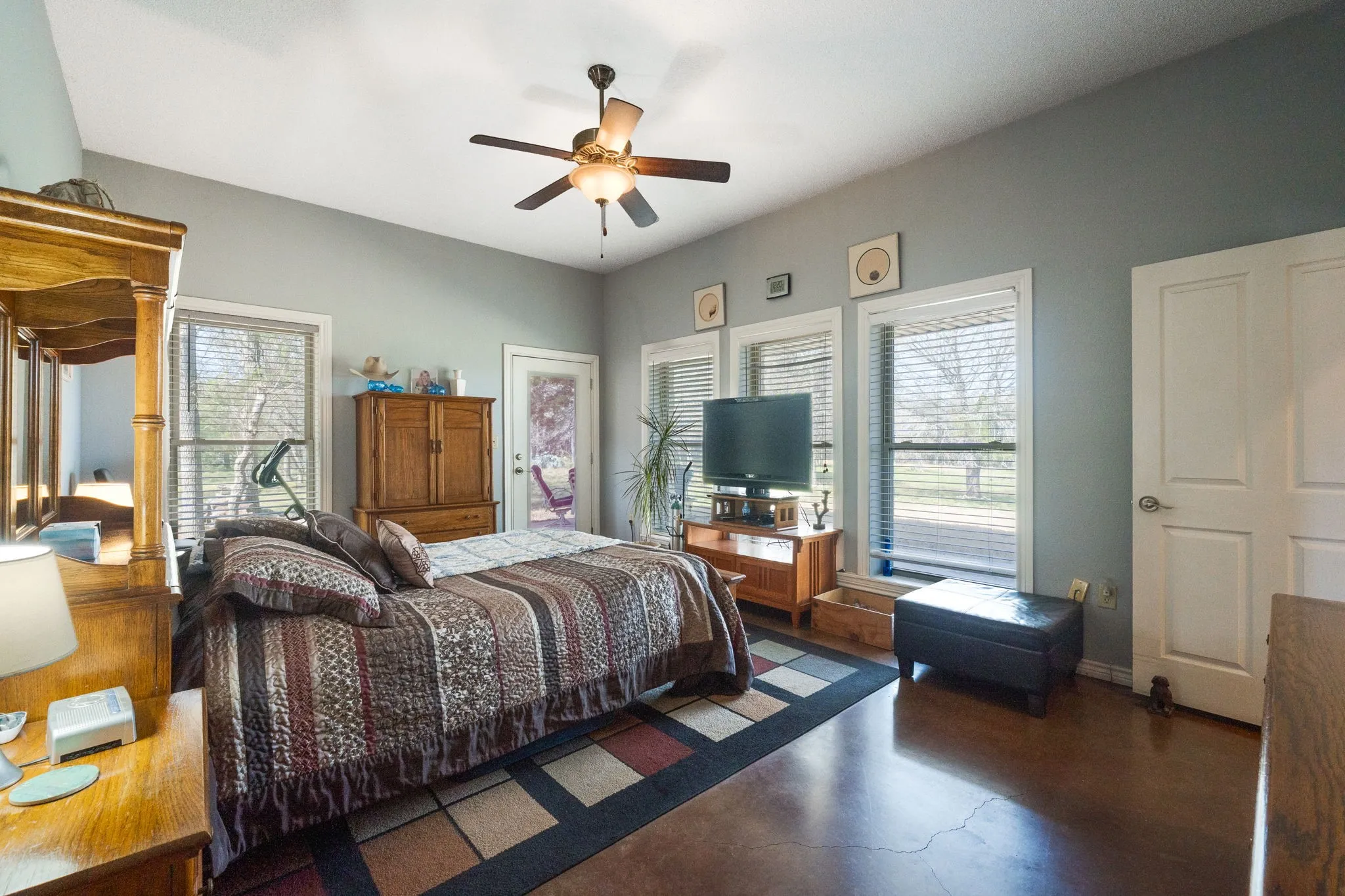 Bedroom with multiple windows and a ceiling fan