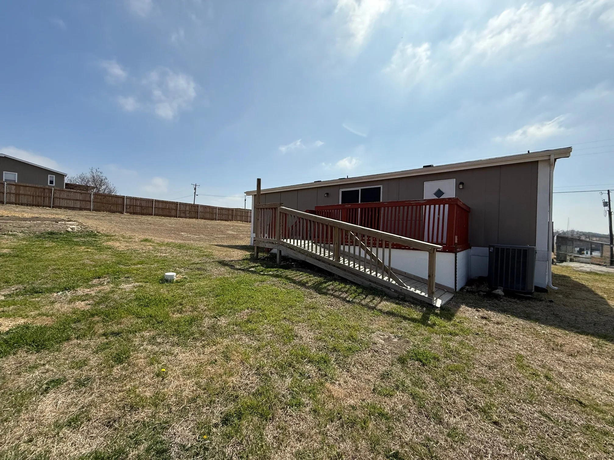 Rear view of property featuring a wooden deck