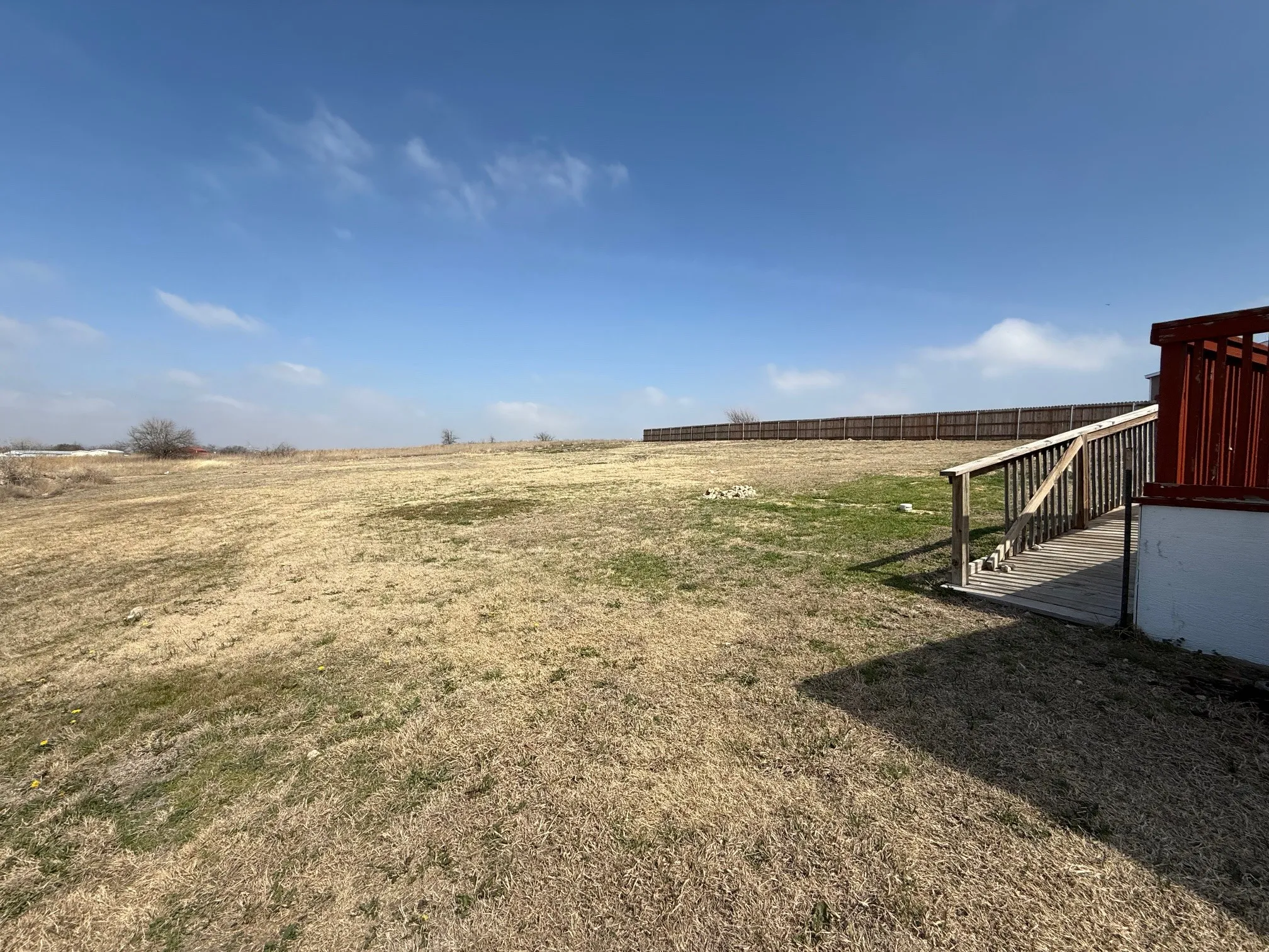View of yard featuring a view of rural / pastoral area and a deck