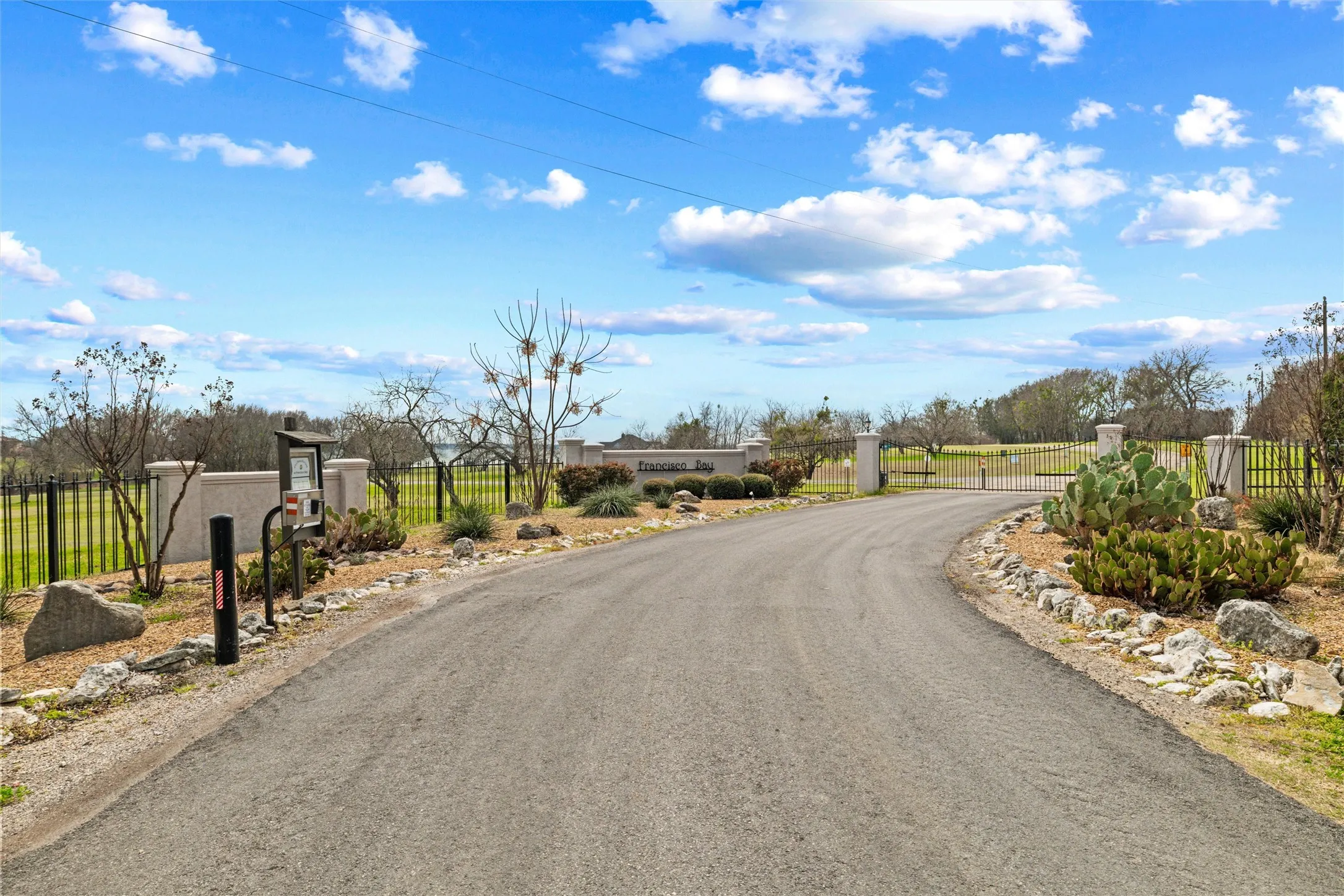 View of asphalt road with a gate